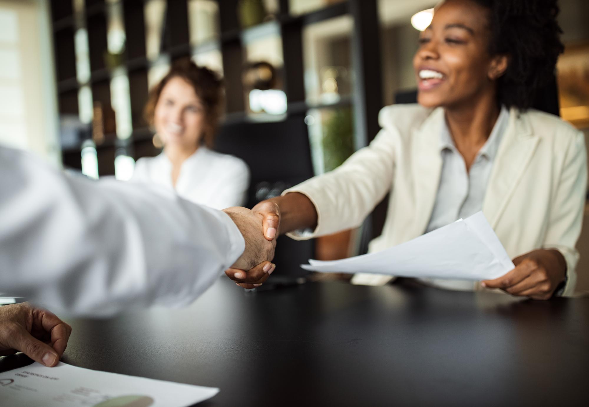 Young people shaking hands in an office