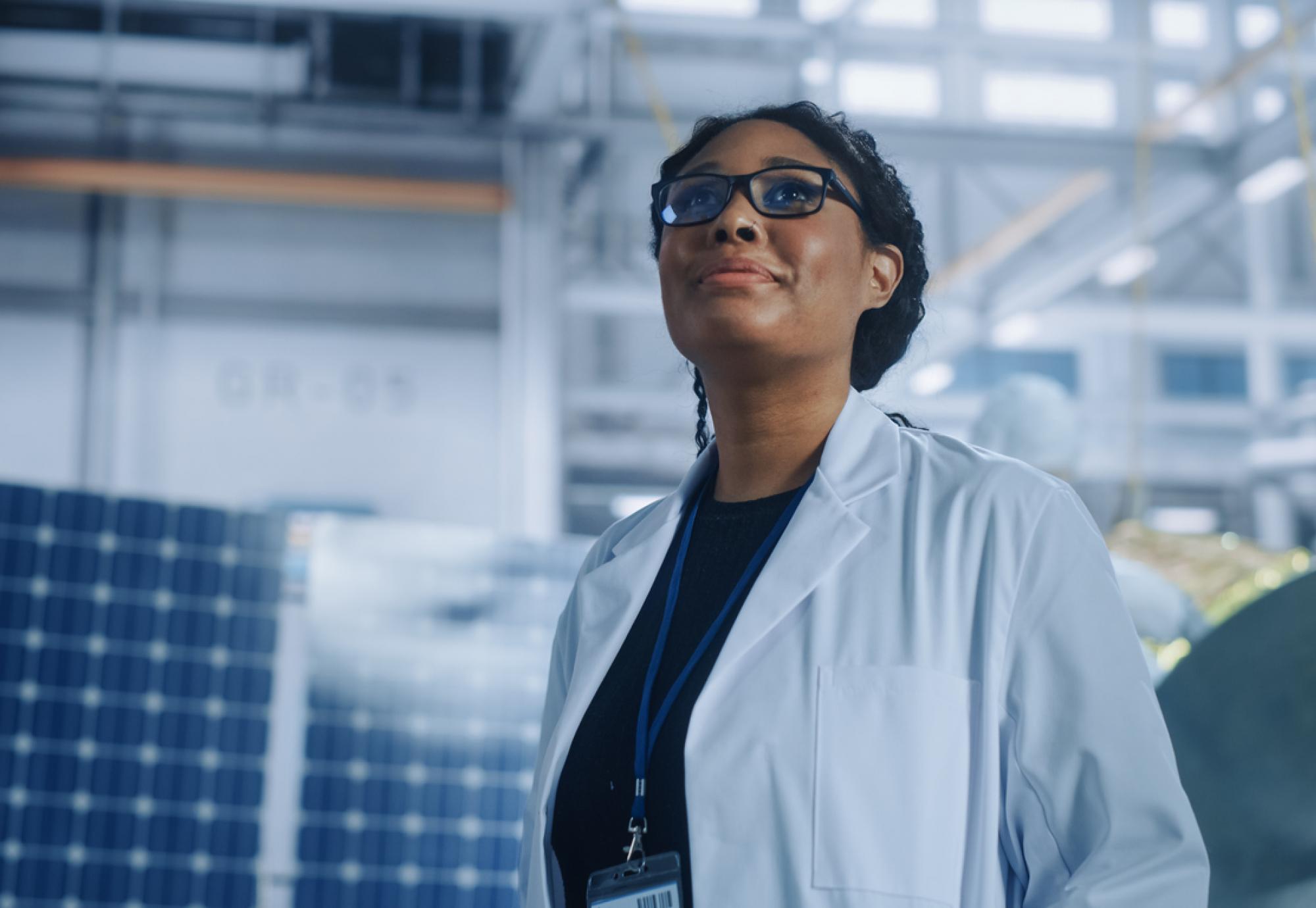 A female researcher is stood looking up