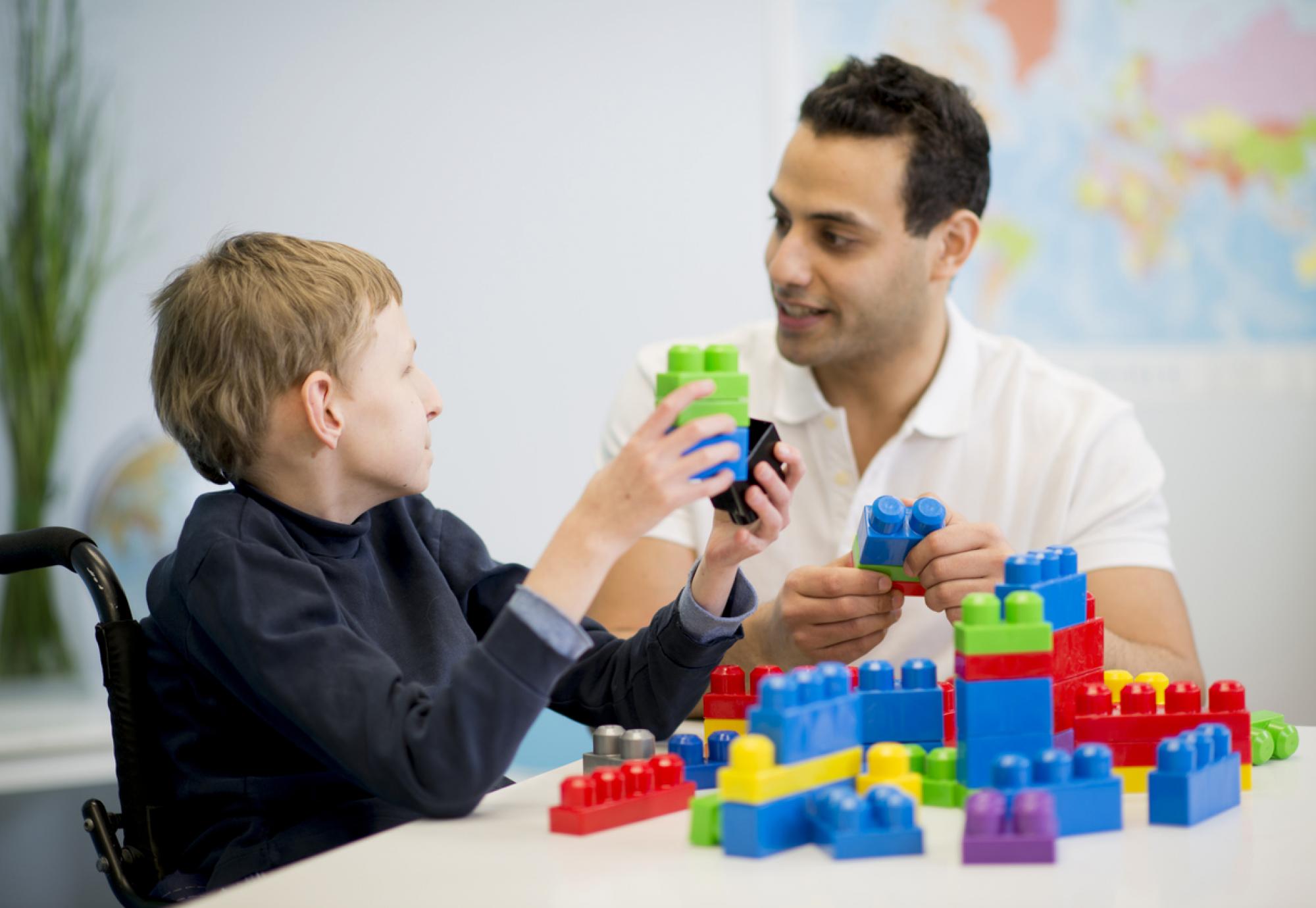 caregiver playing with a child with special needs