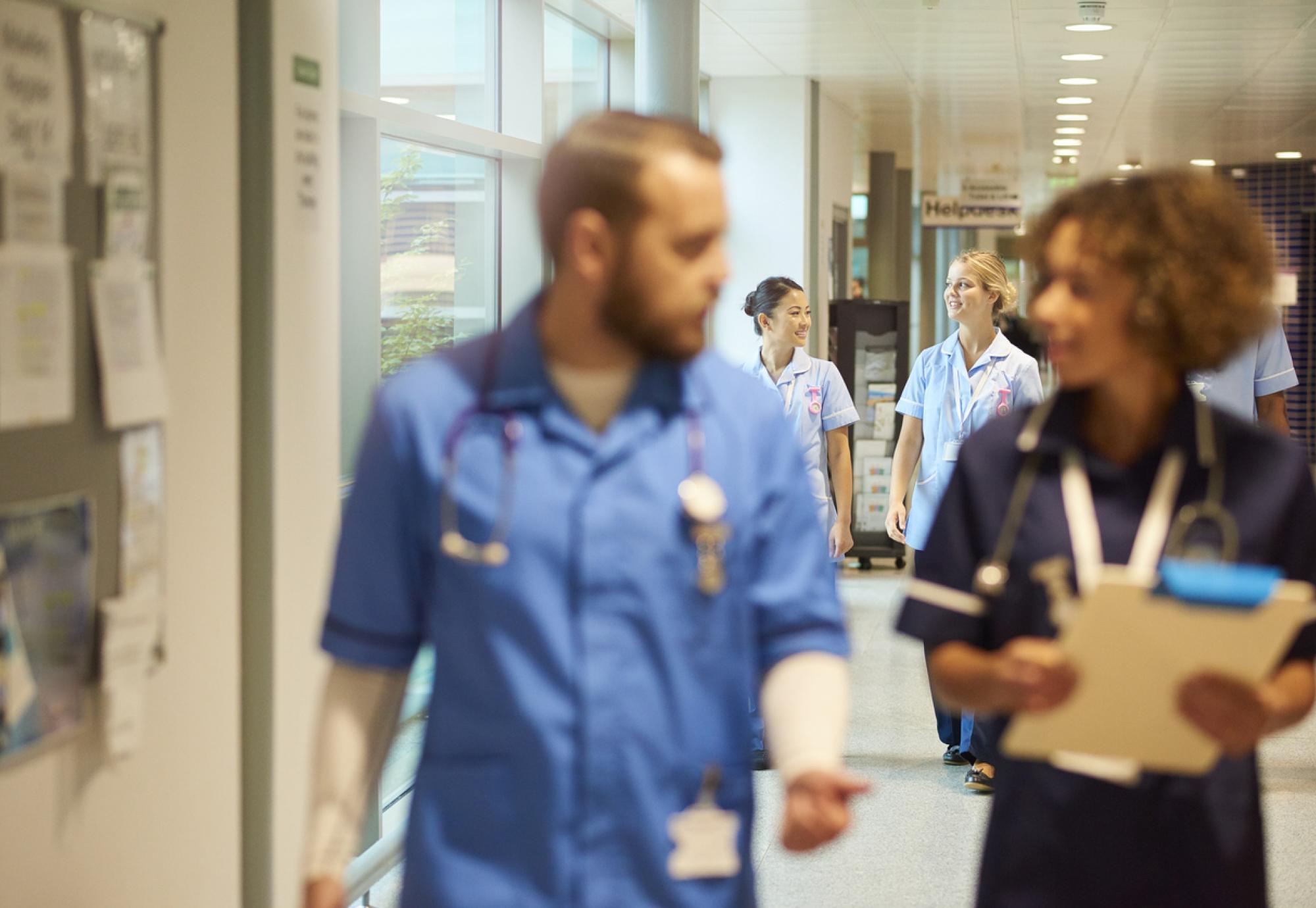 NHS nurses walking down a corridor