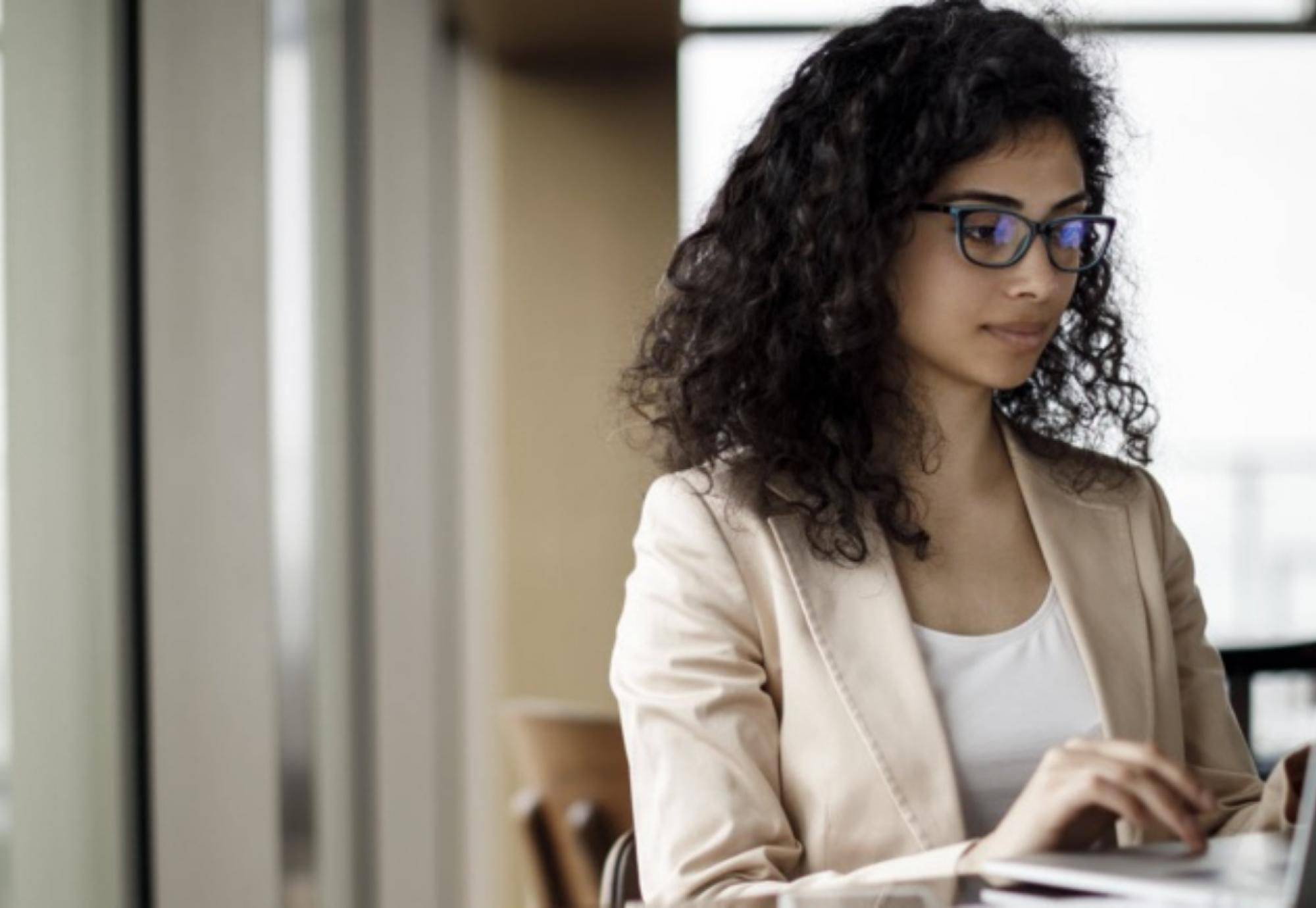 Photo of a woman working at a computer