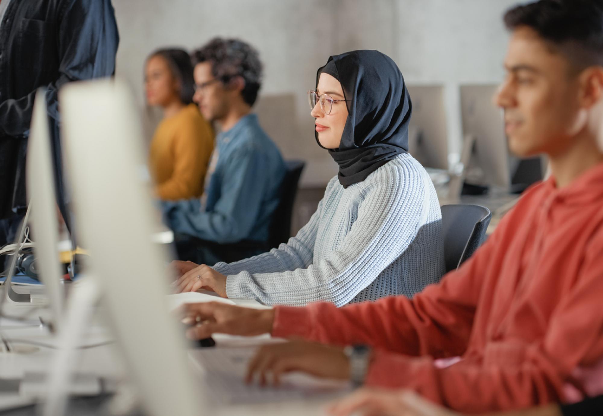 Adult learners working at computer