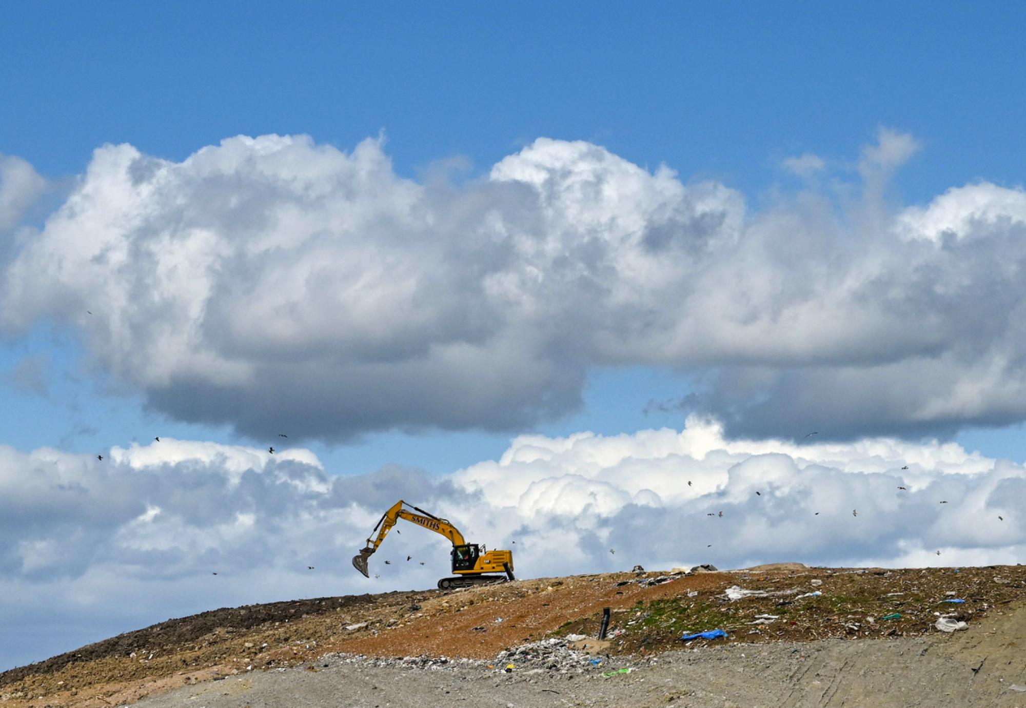 A digger on a landfill site