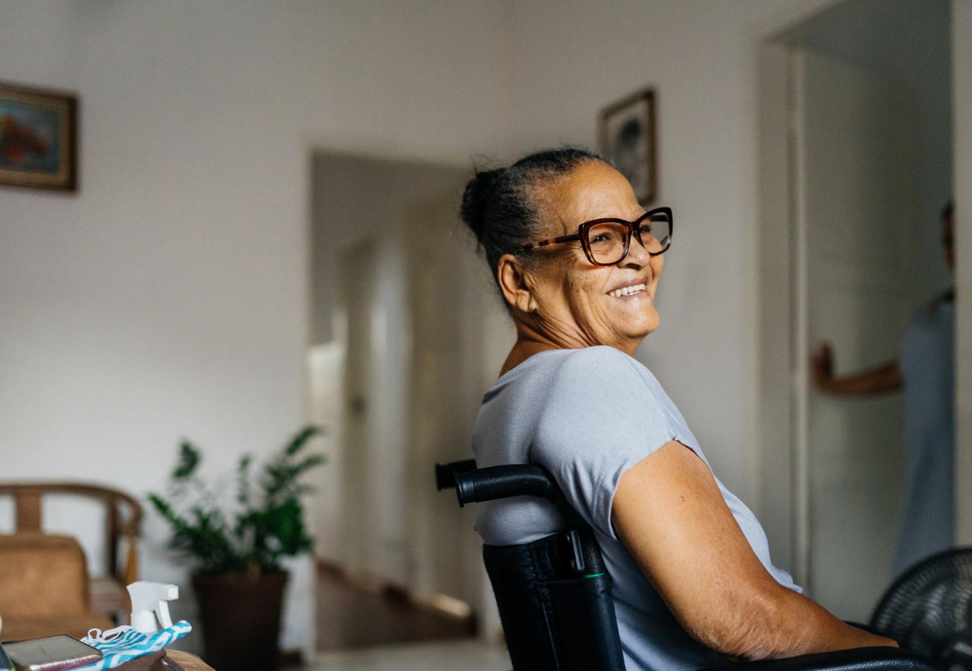 A woman in a wheelchair smiles