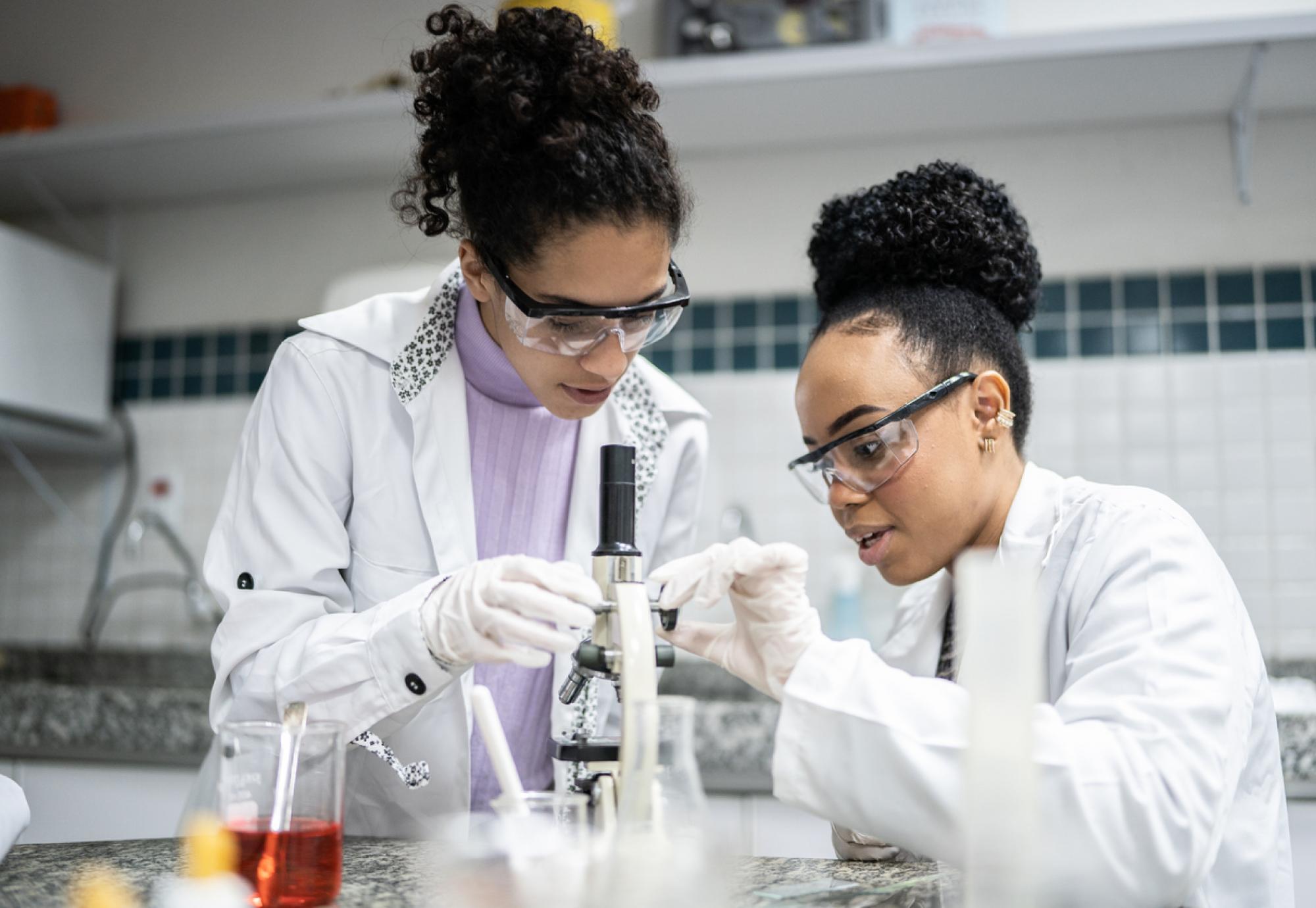 Teenage student using the microscope in the laboratory