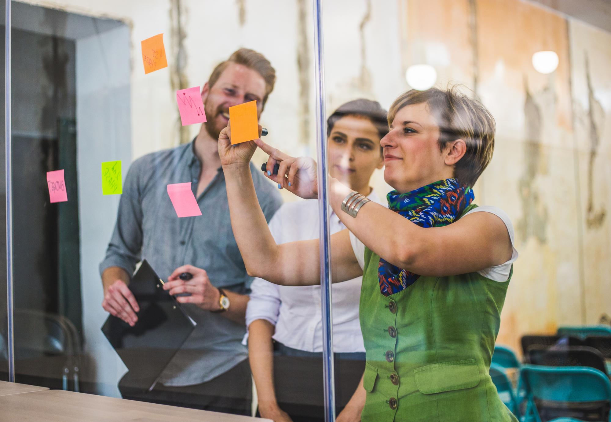 Three adults working together in an office space