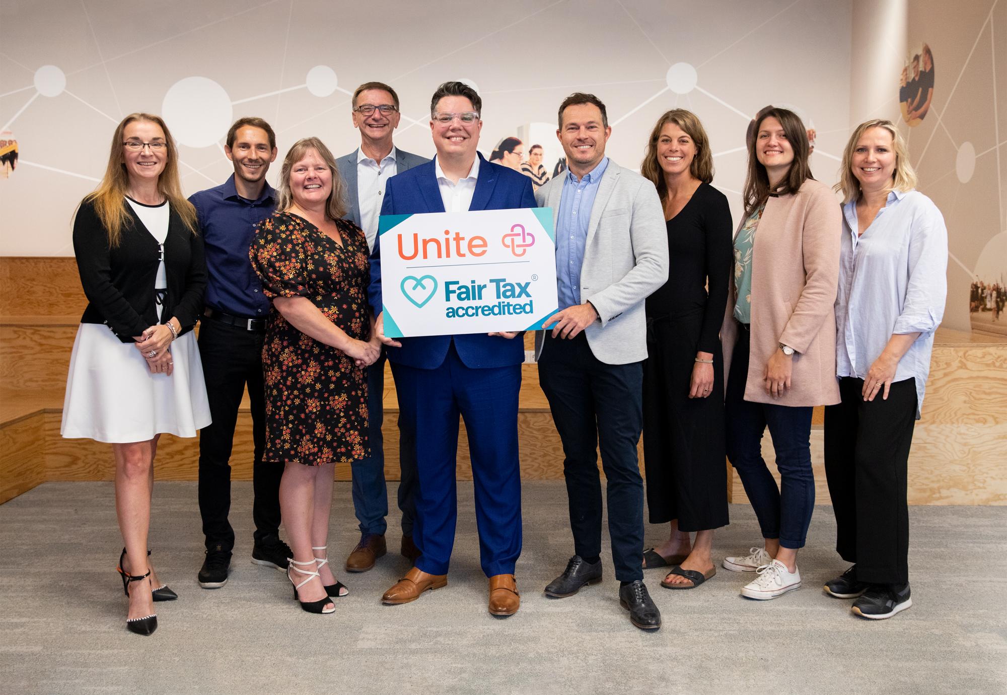 Graham Drummond hands over Fair Tax Mark accreditation to the Unite team