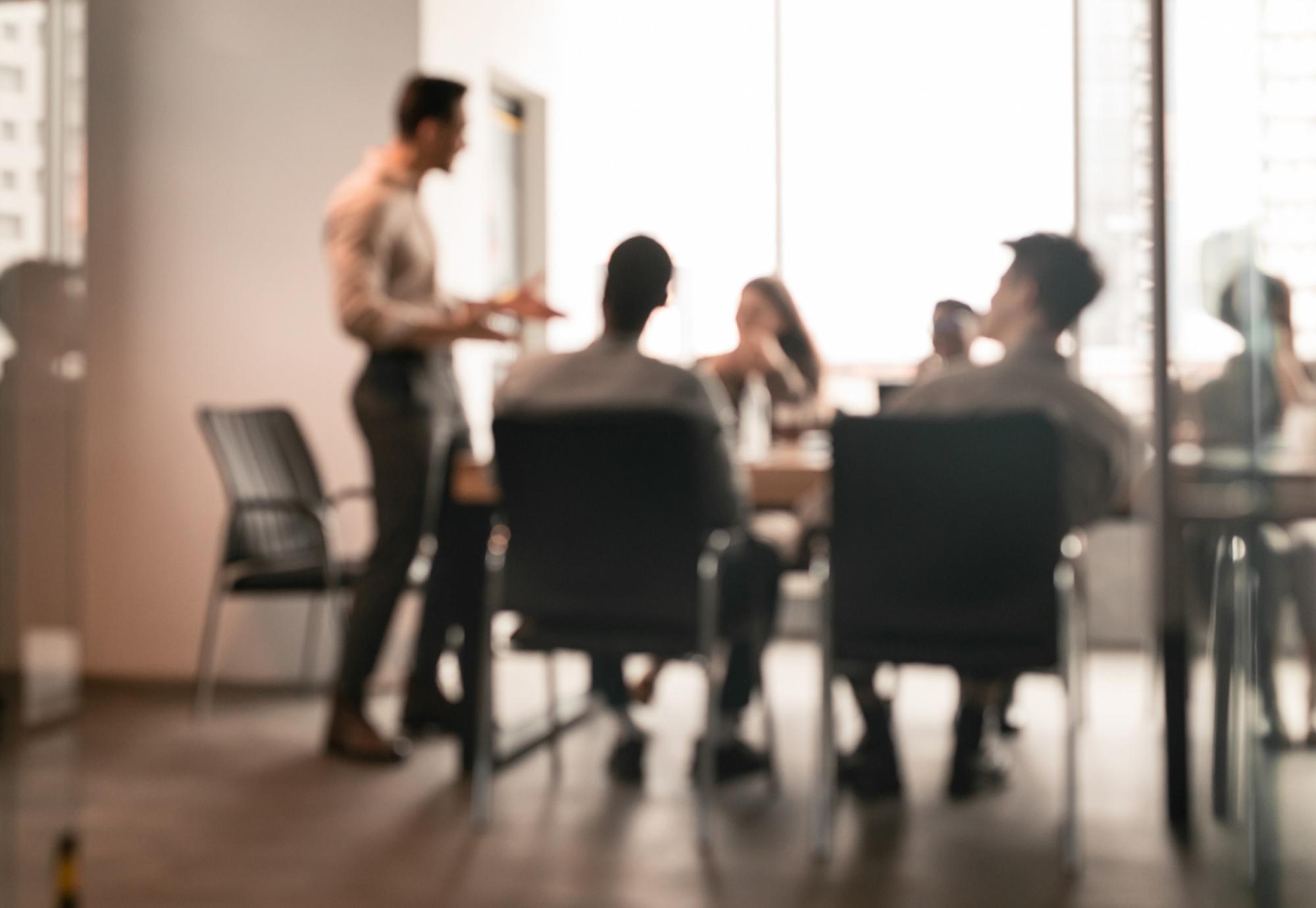 People gathered round a desk in an office space