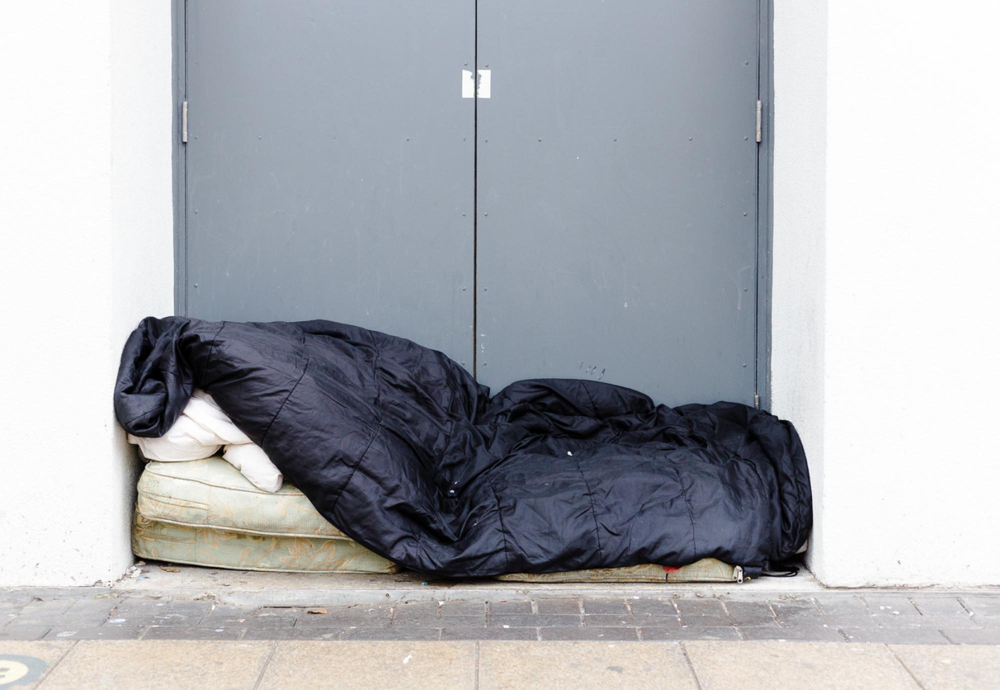 Man sleeping rough in a doorway