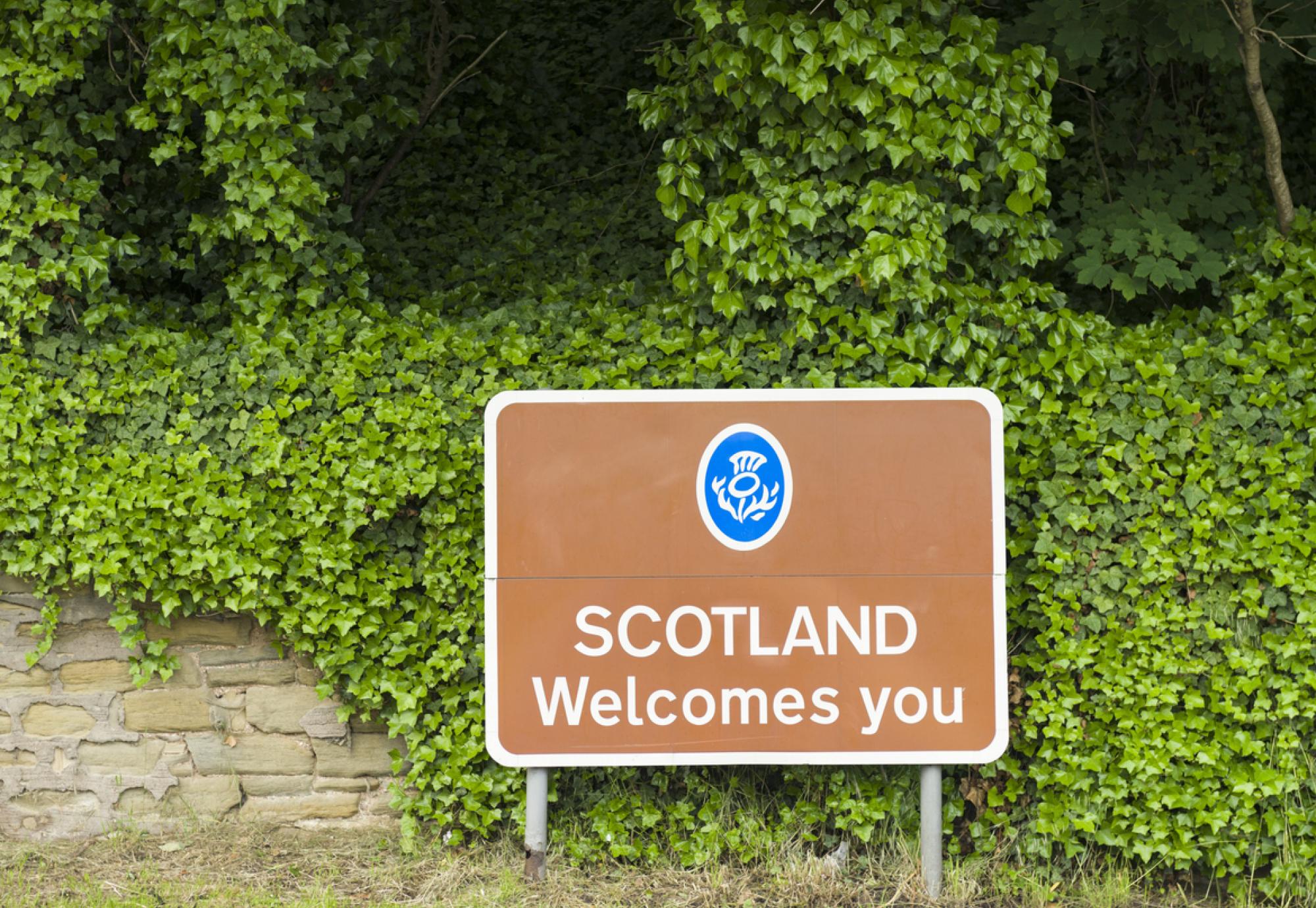 Road saying 'Scotland welcomes you'