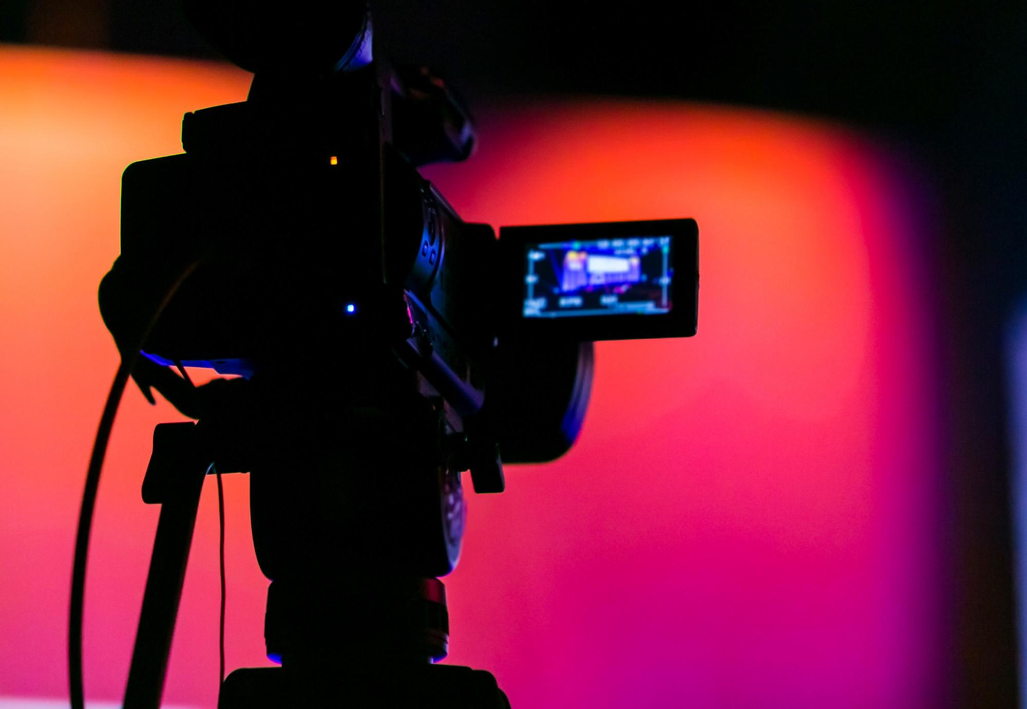 Silhouette of a camera filming