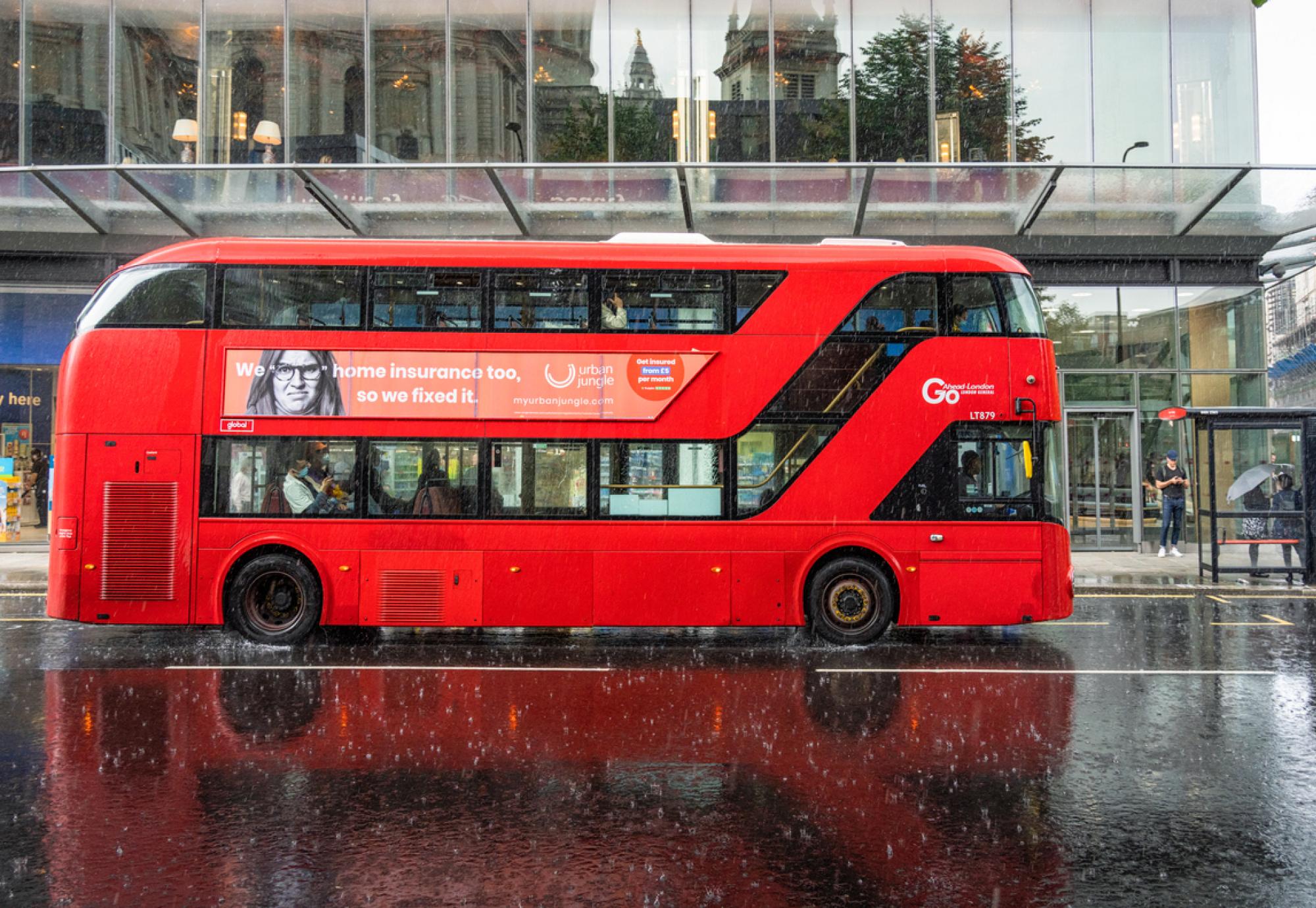 Side view of a london bus in the rain