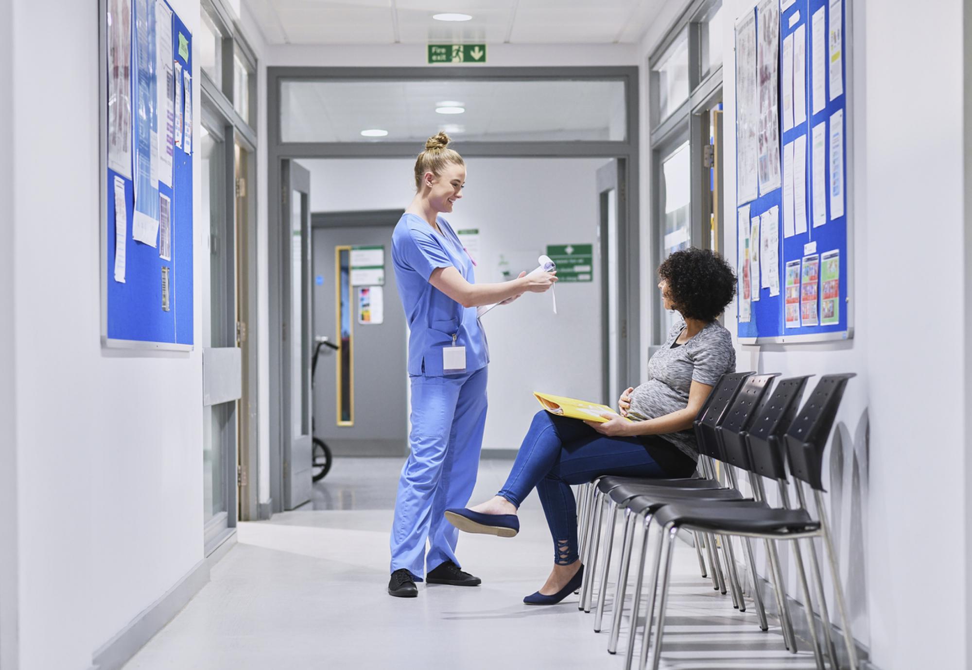 NHS nurse talking to a pregnant patient