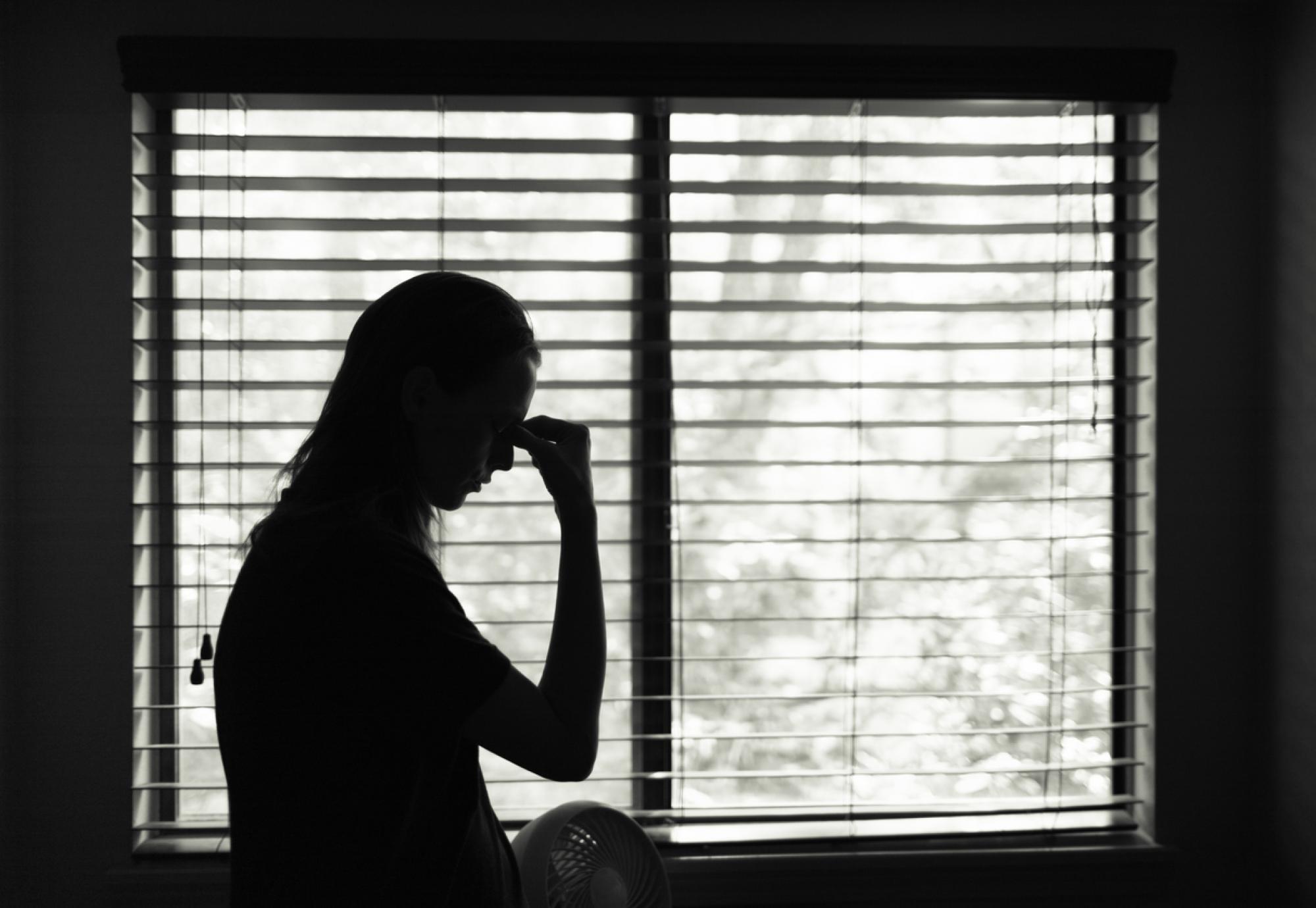 Silhouette of woman looking sad