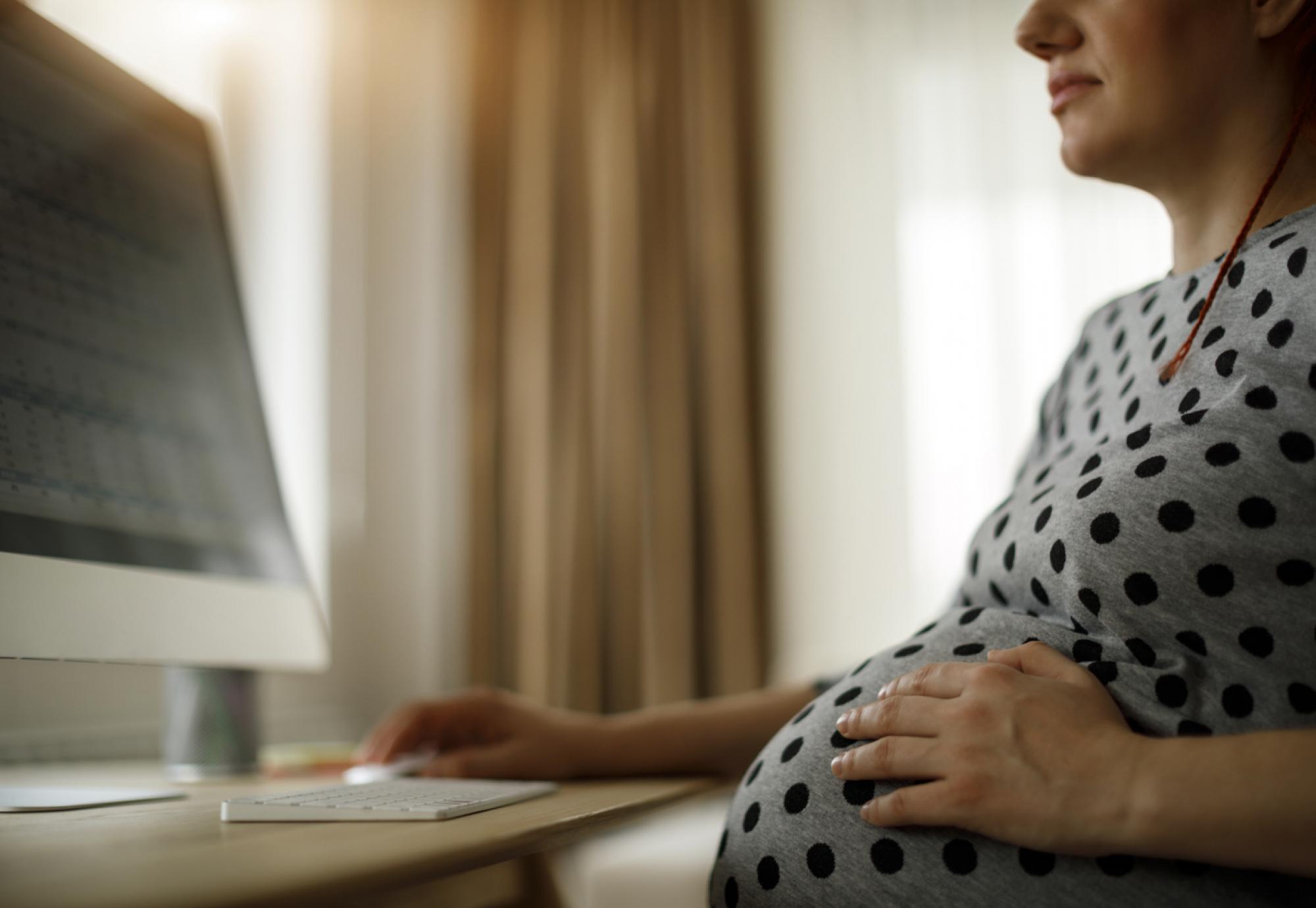 Pregnant woman working on computer