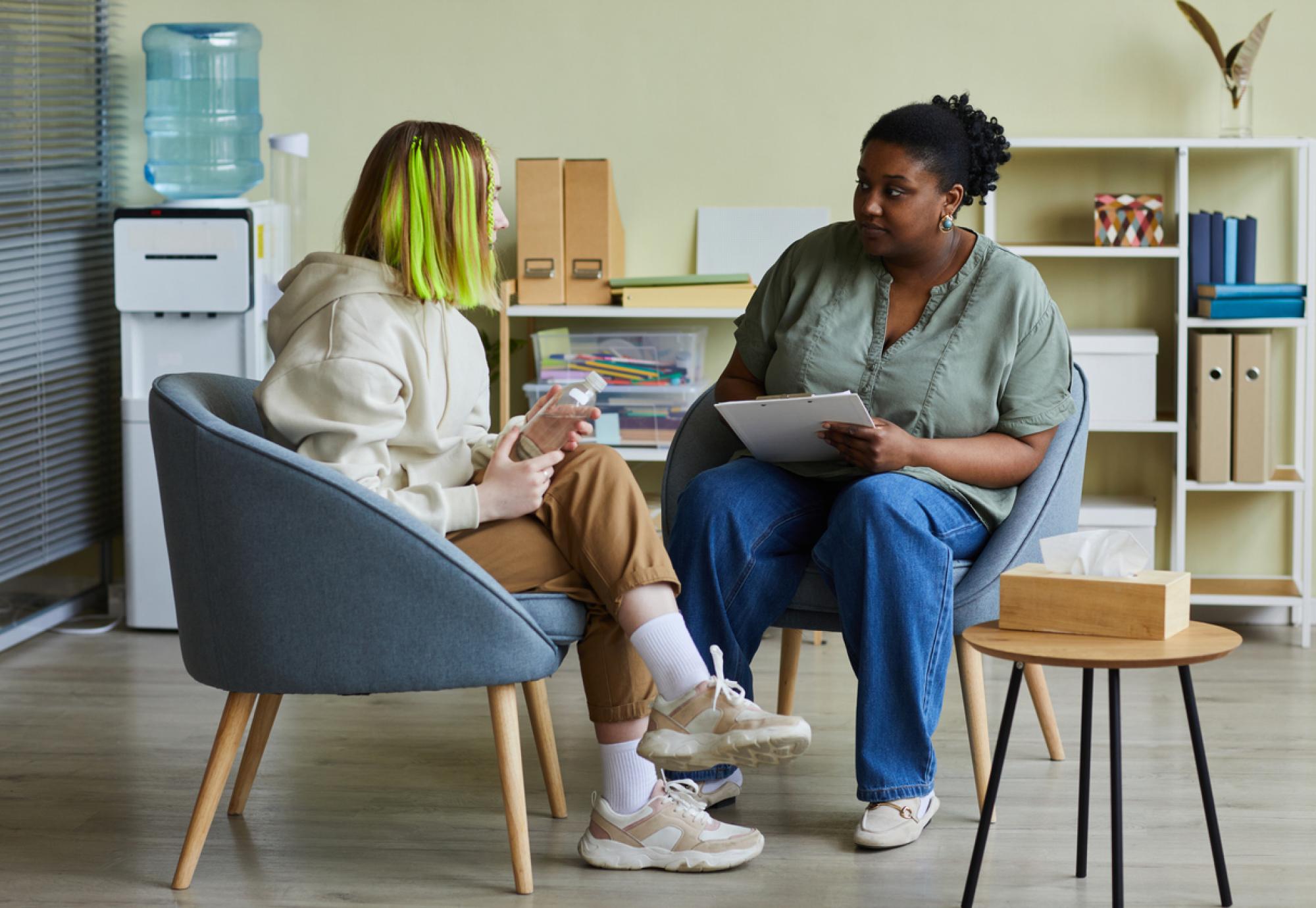 Social worker chatting to teenage girl