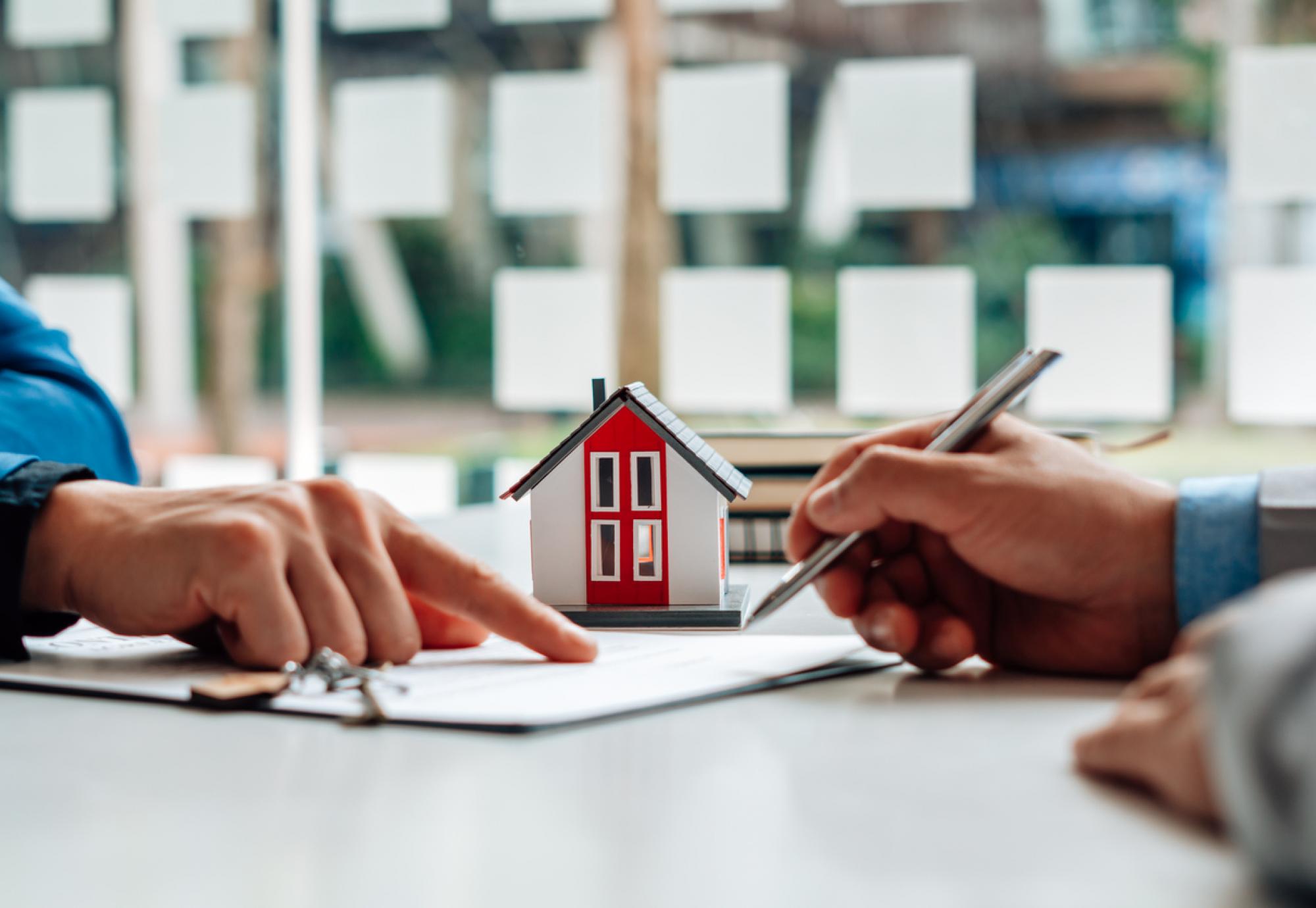 Two people signing a tenancy agreement