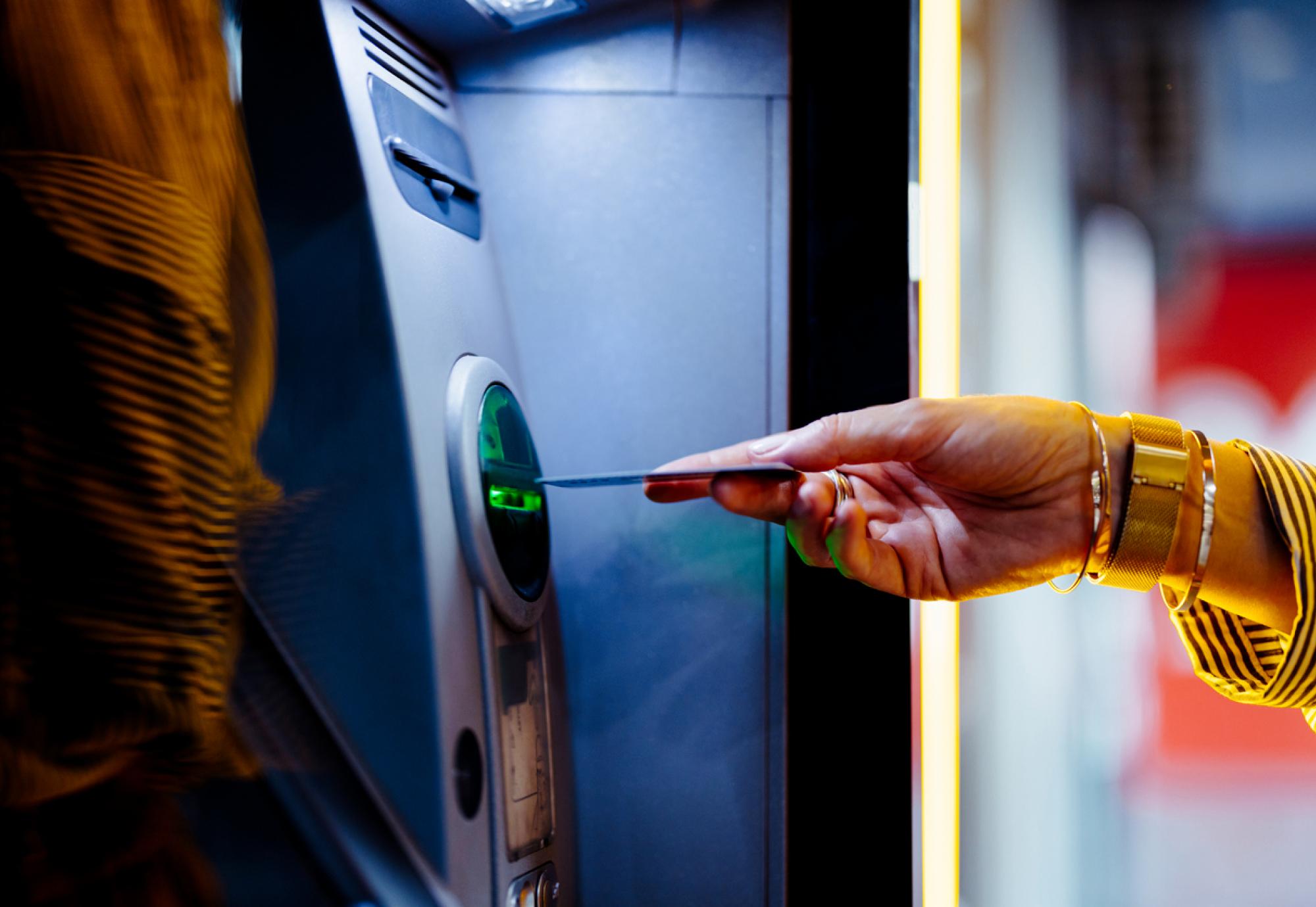 Woman taking cash out of an ATM