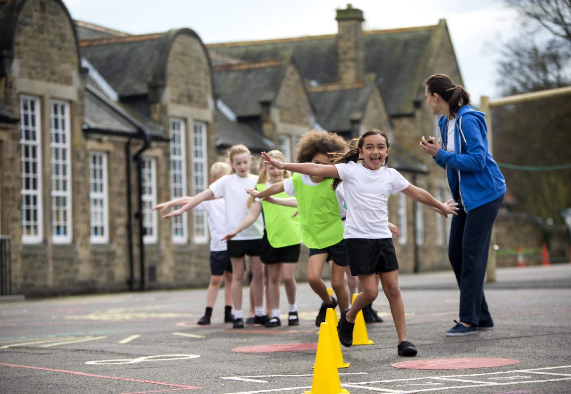 Children doing physical education in a school playground