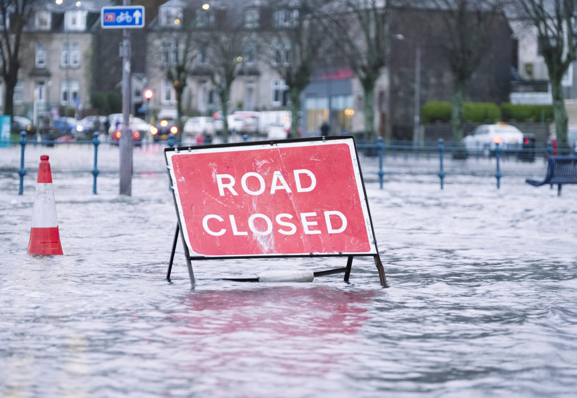 Road closed sign in a flooded street