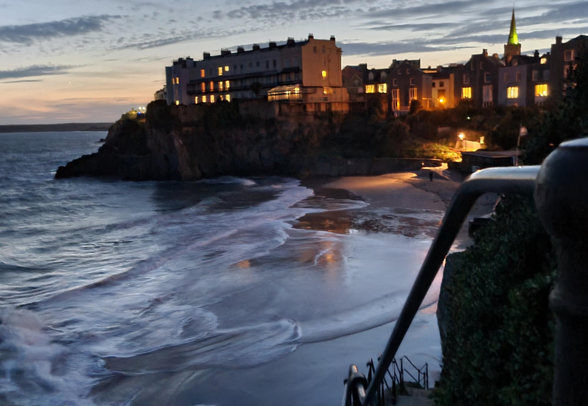 Sunset view of houses at the top of cliffs in Tenby