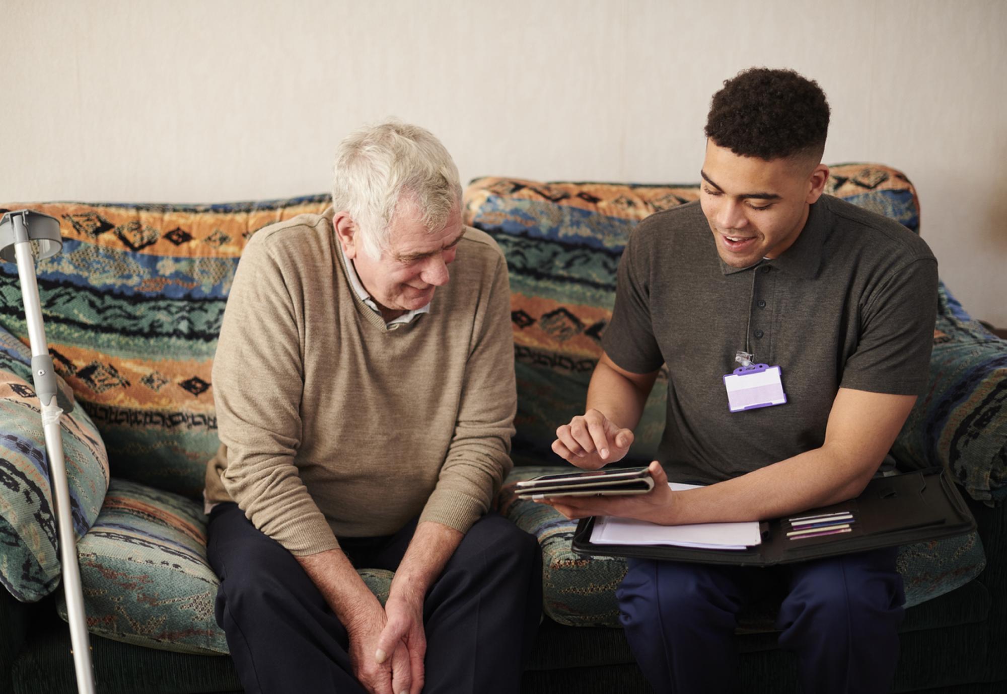 Carer using an iPad with a patient