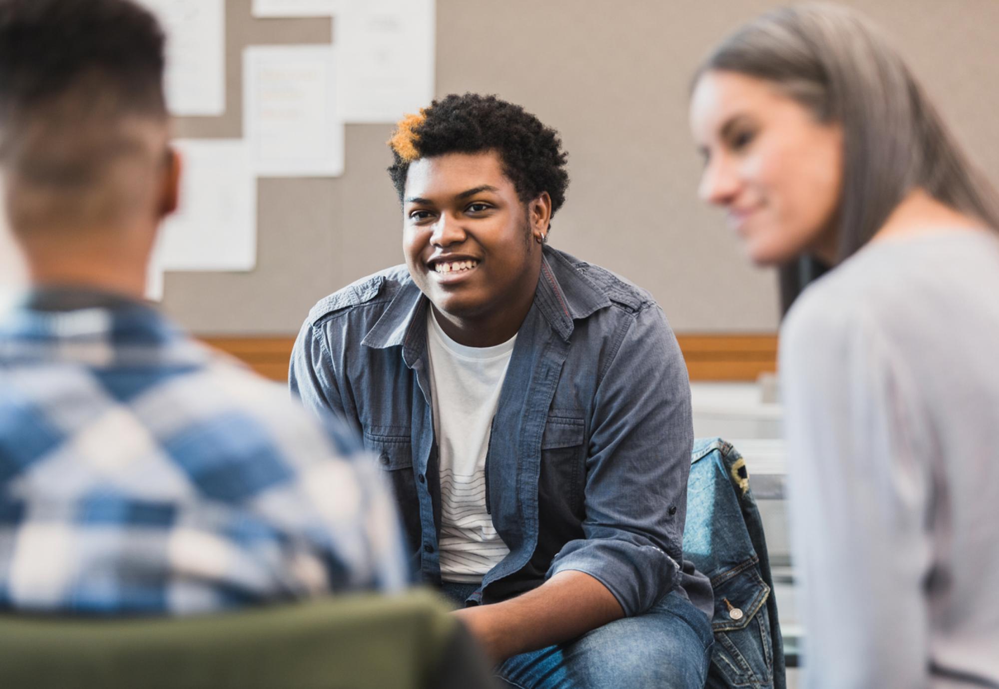 Young person talking to adults