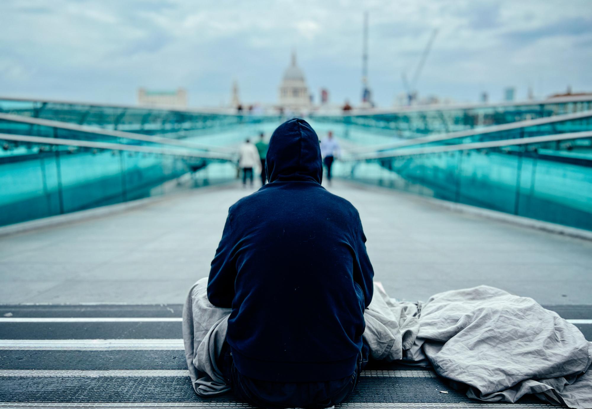 Homeless man in London with St Paul's Cathedral in the background