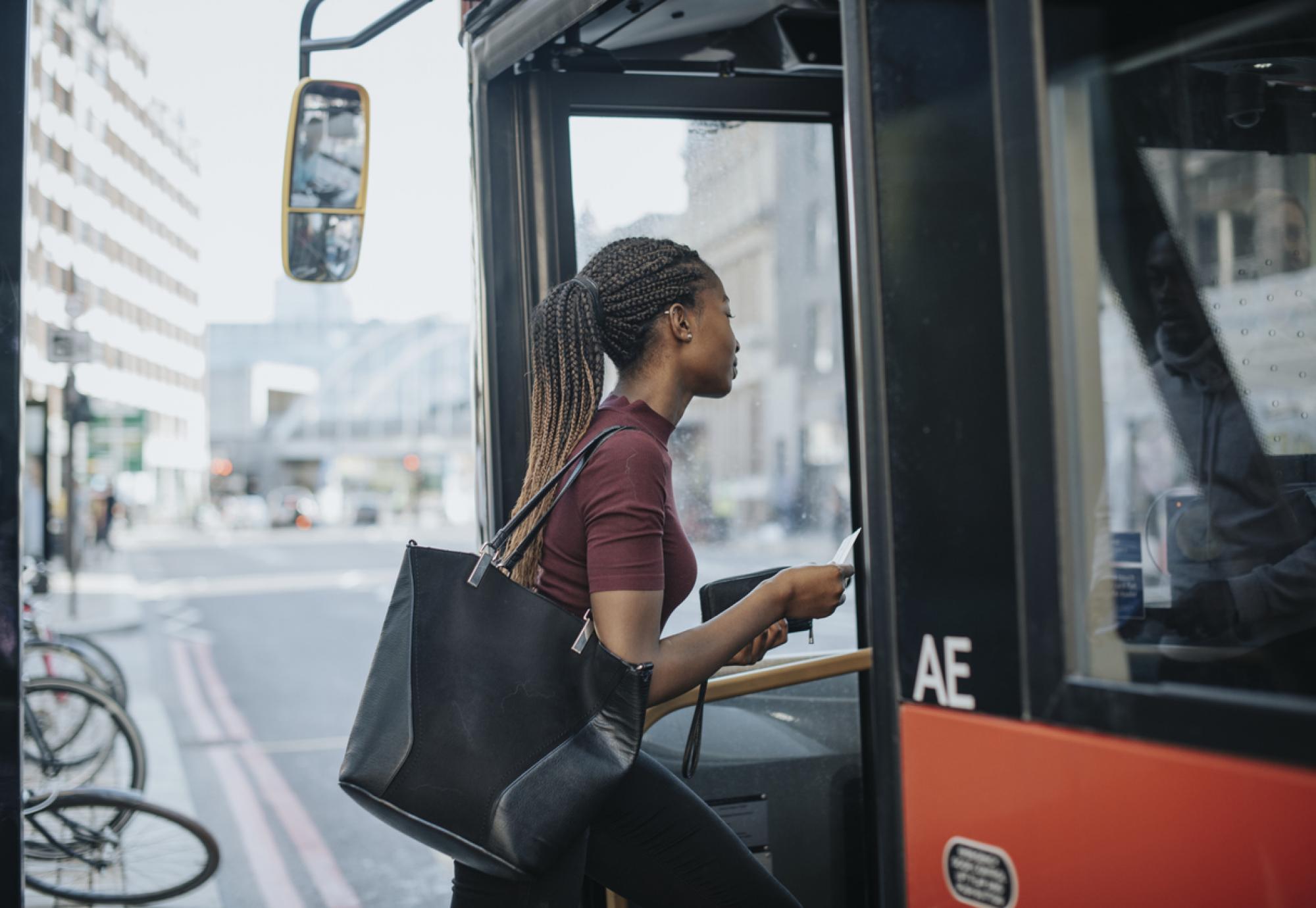 Woman getting onto a bus