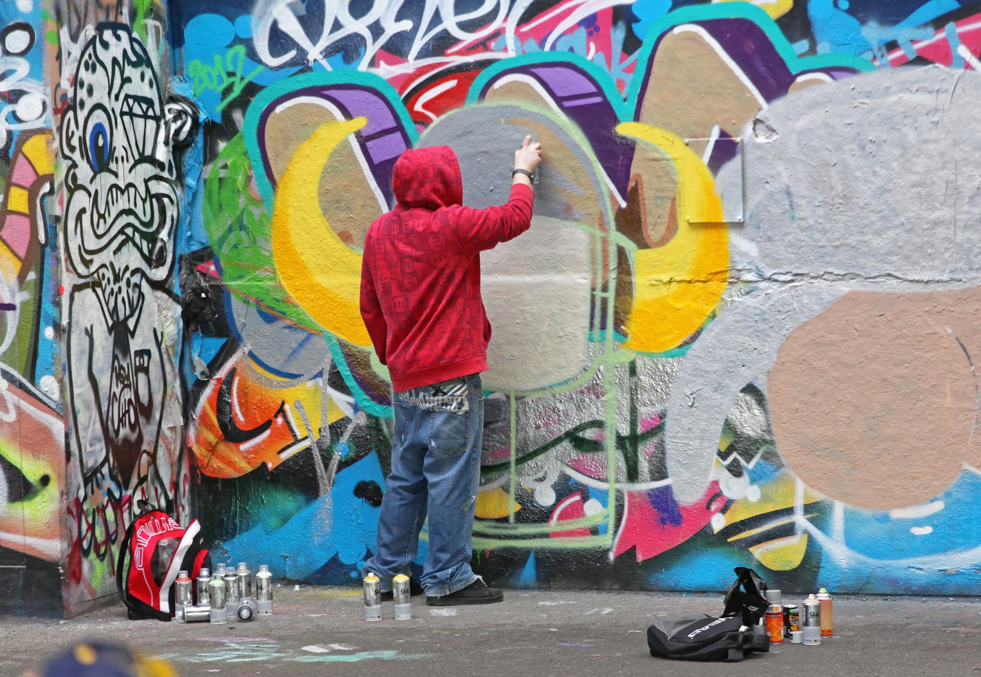 Man spray painting a well