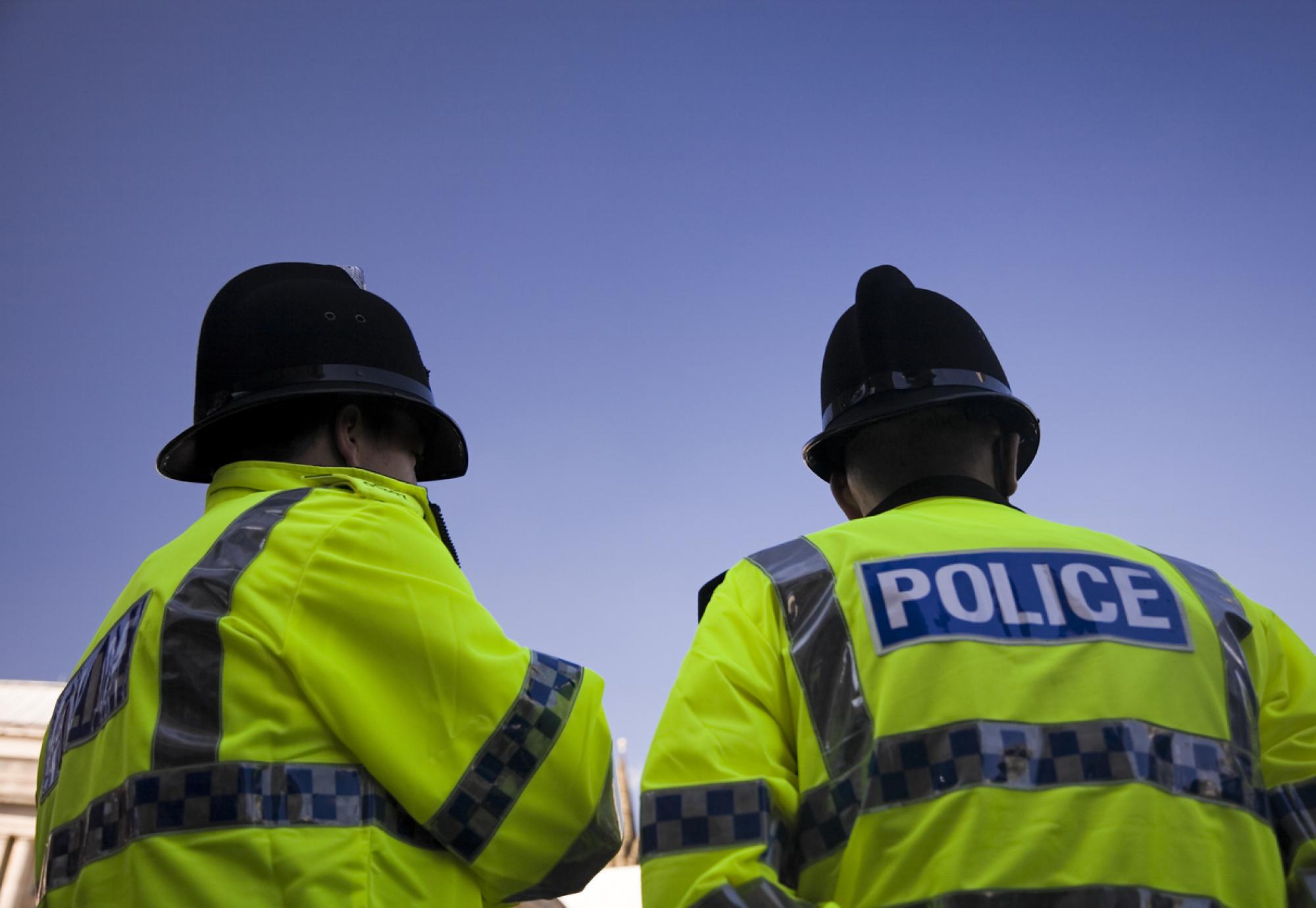 Police officers from below. Blue skies