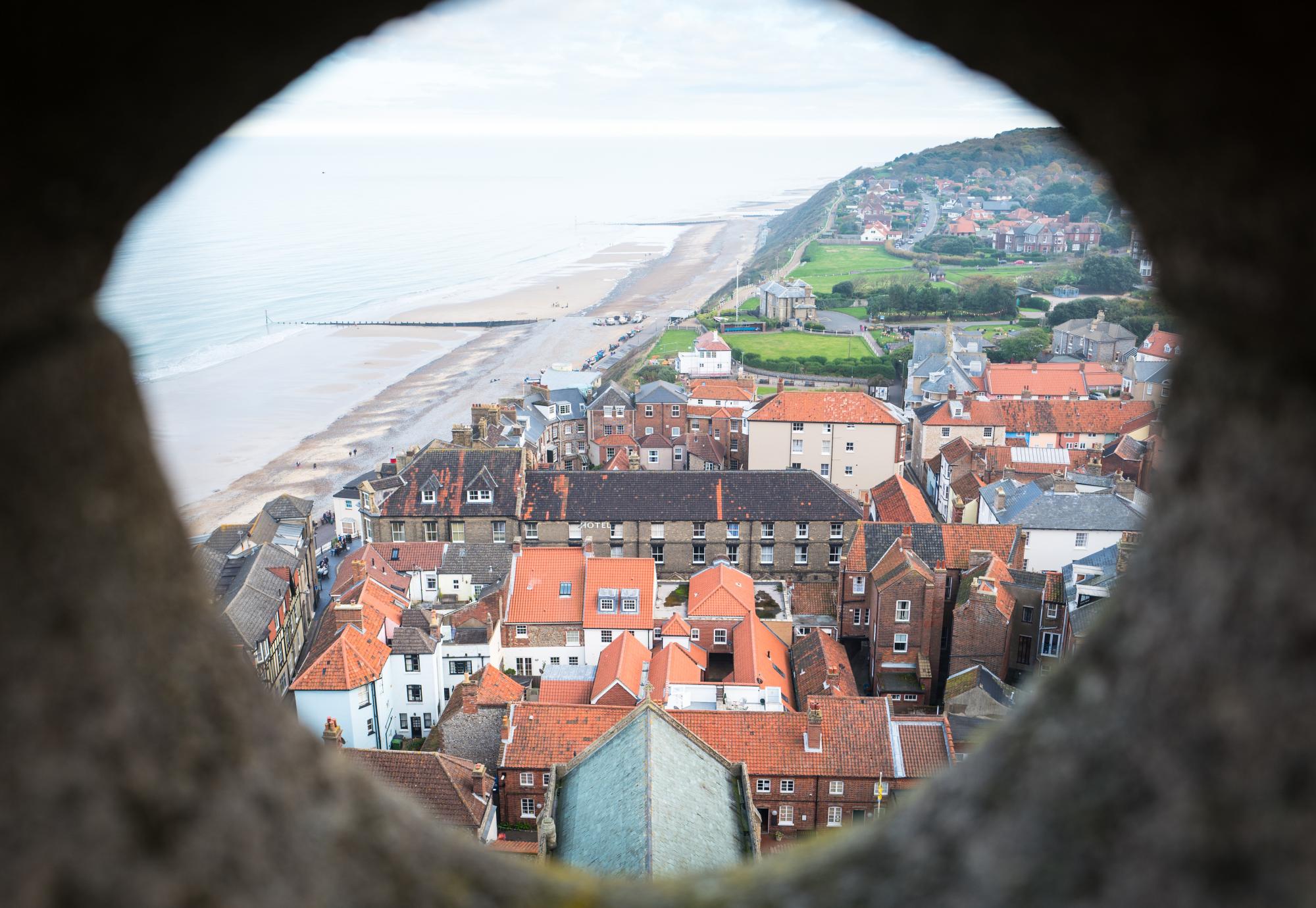 Aerial view of a town in North Norfolk through a stone window