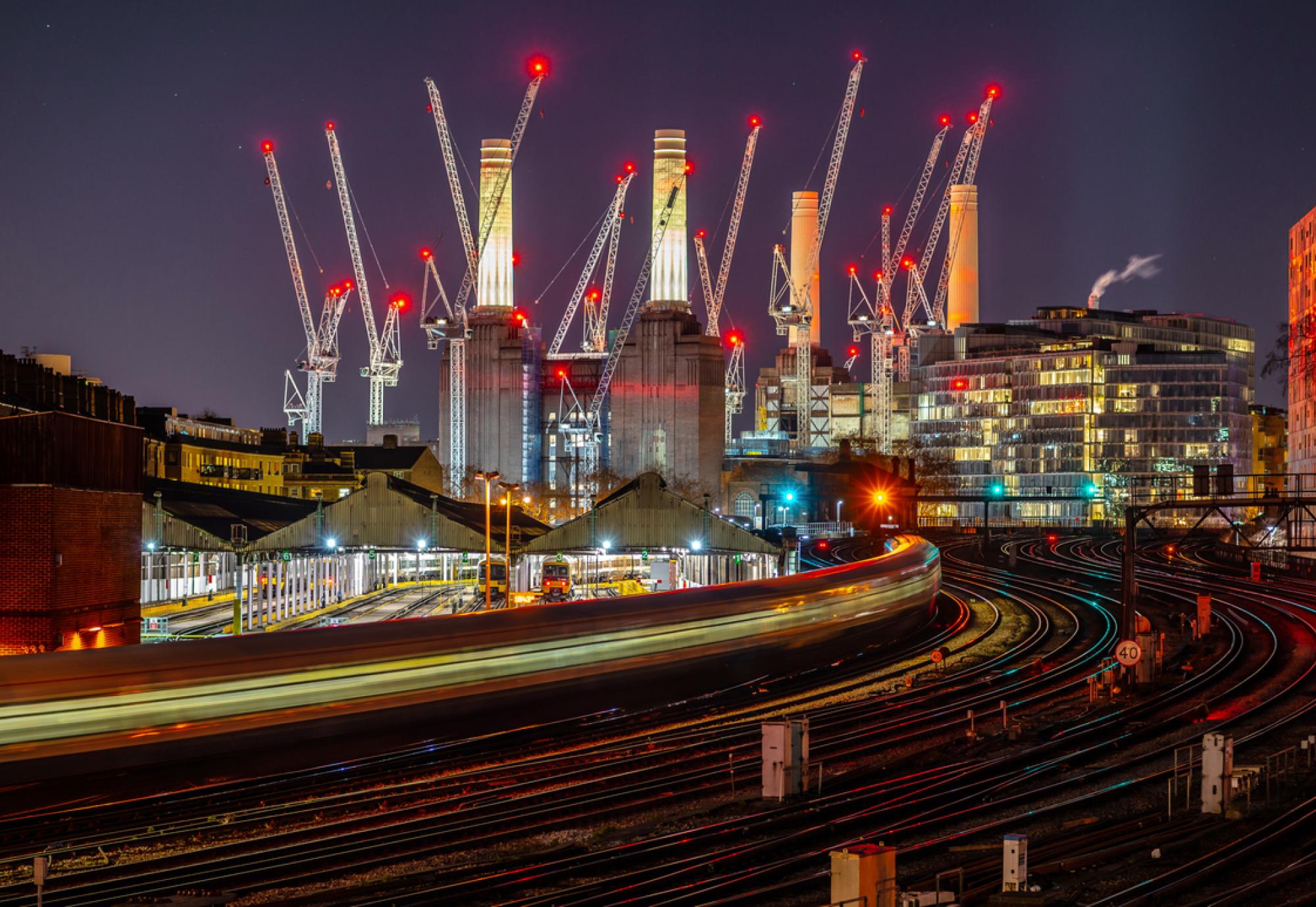 Battersea power station and rail links at night