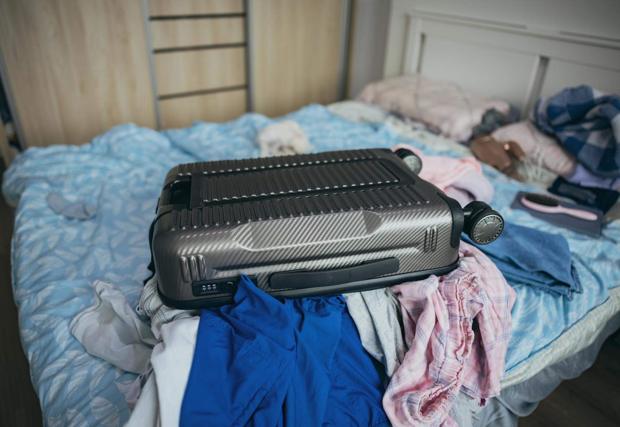 Suitcase on a bed of a temporary accomodation