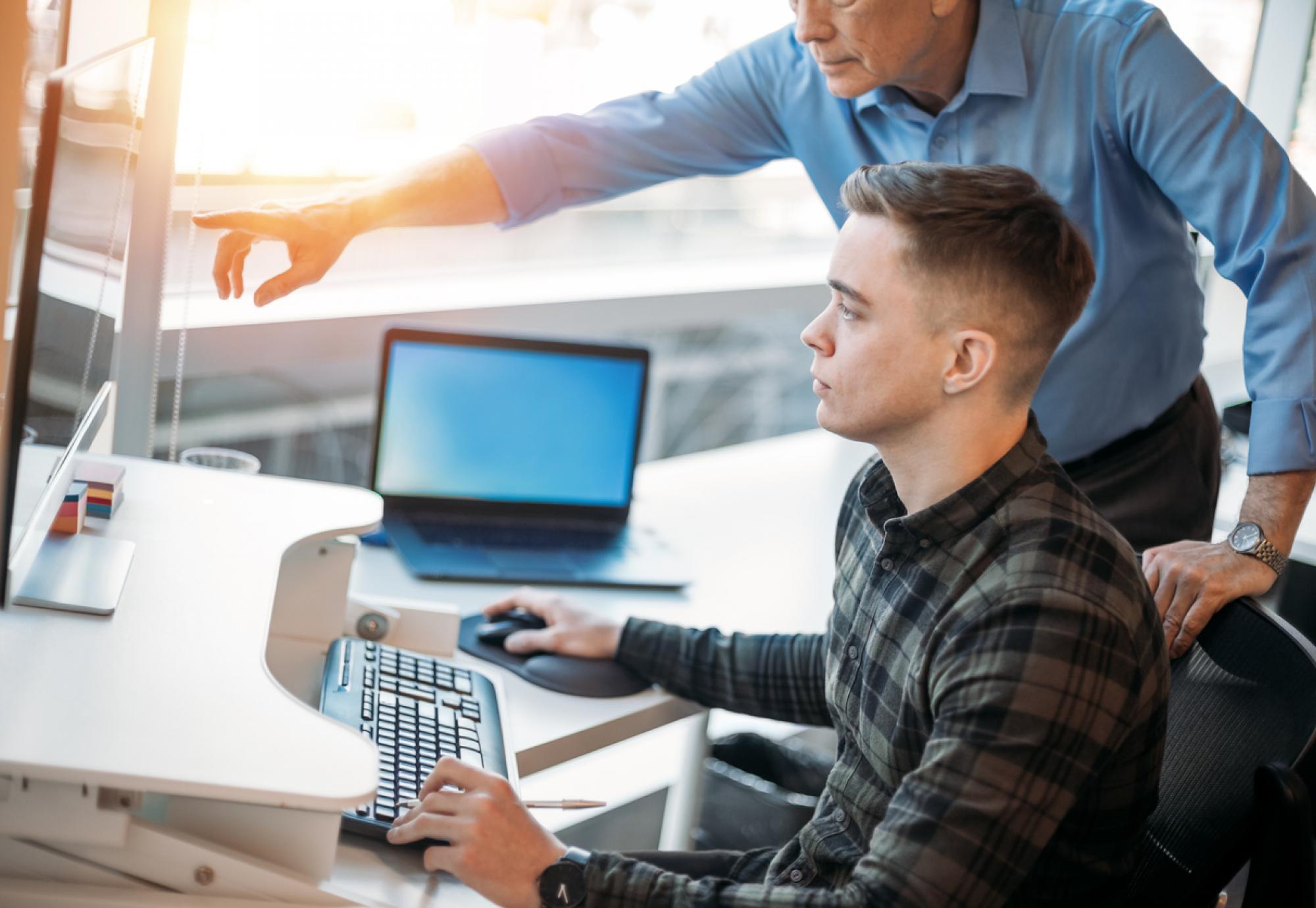 Young man on work experience at a computer