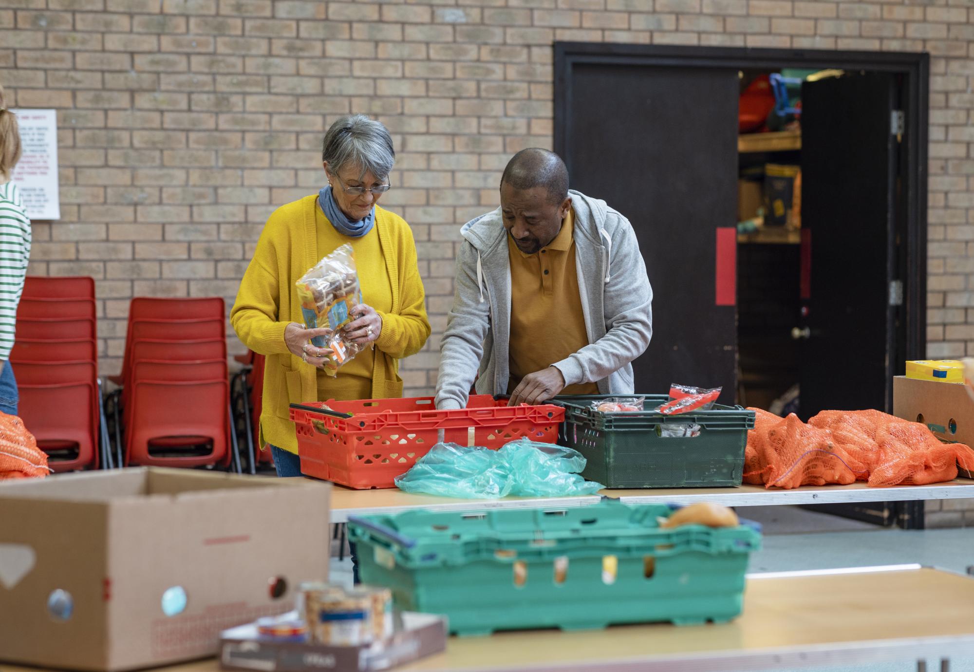 Woman and a man setting up a food bank in the North of England