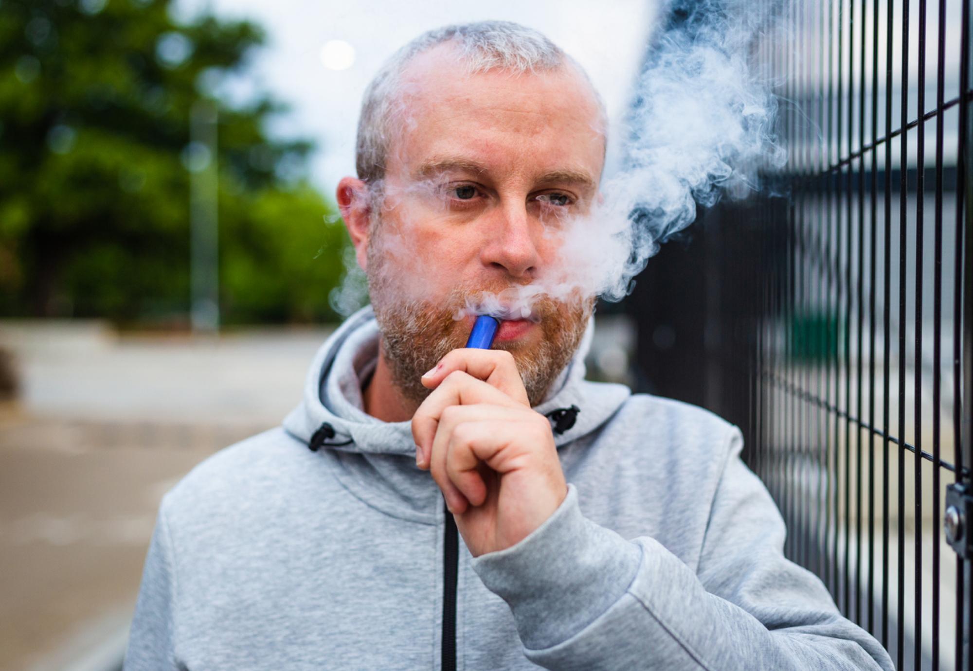 Man using a disposable vape