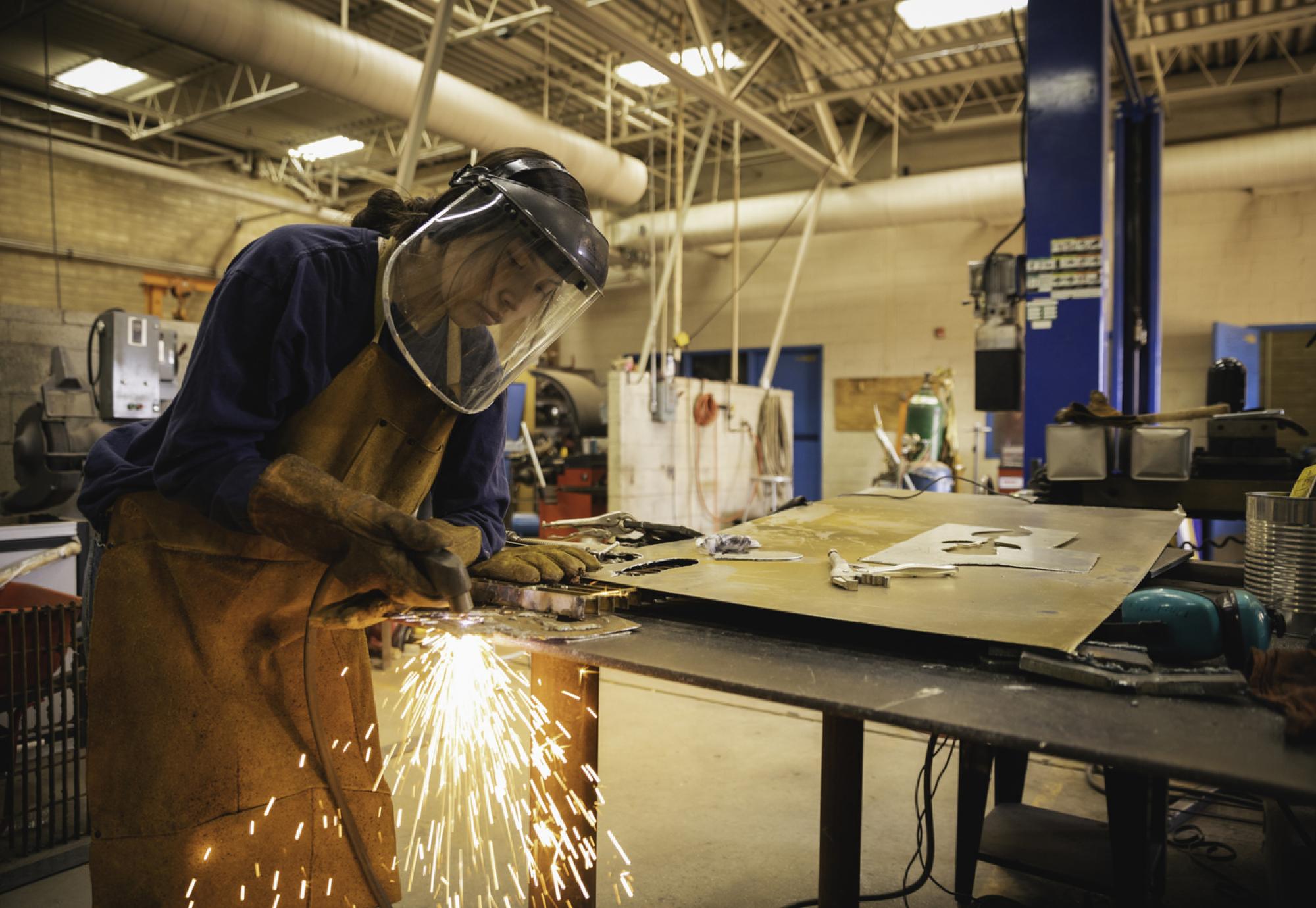 Young woman welding