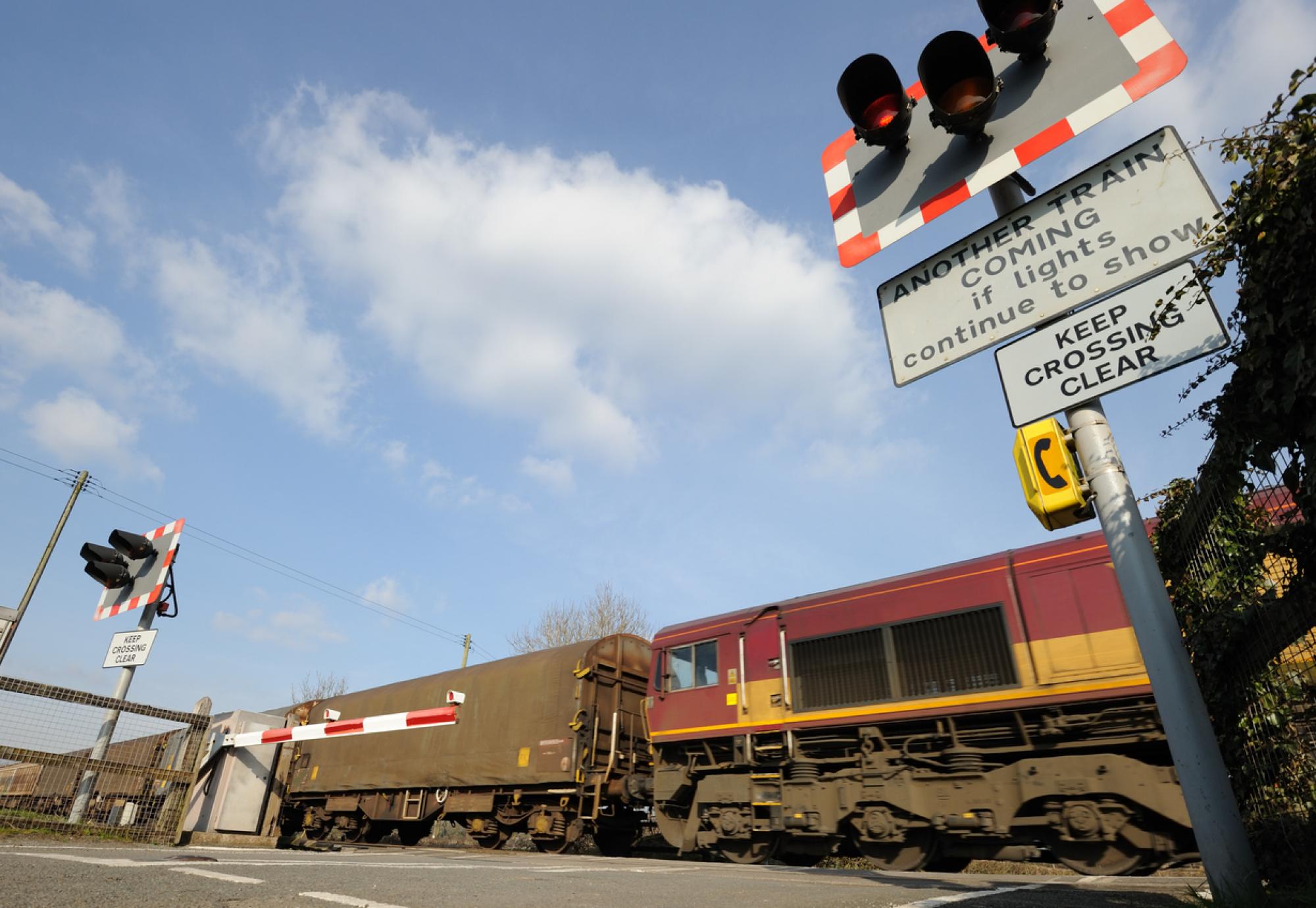 Freight train going through a level crossing