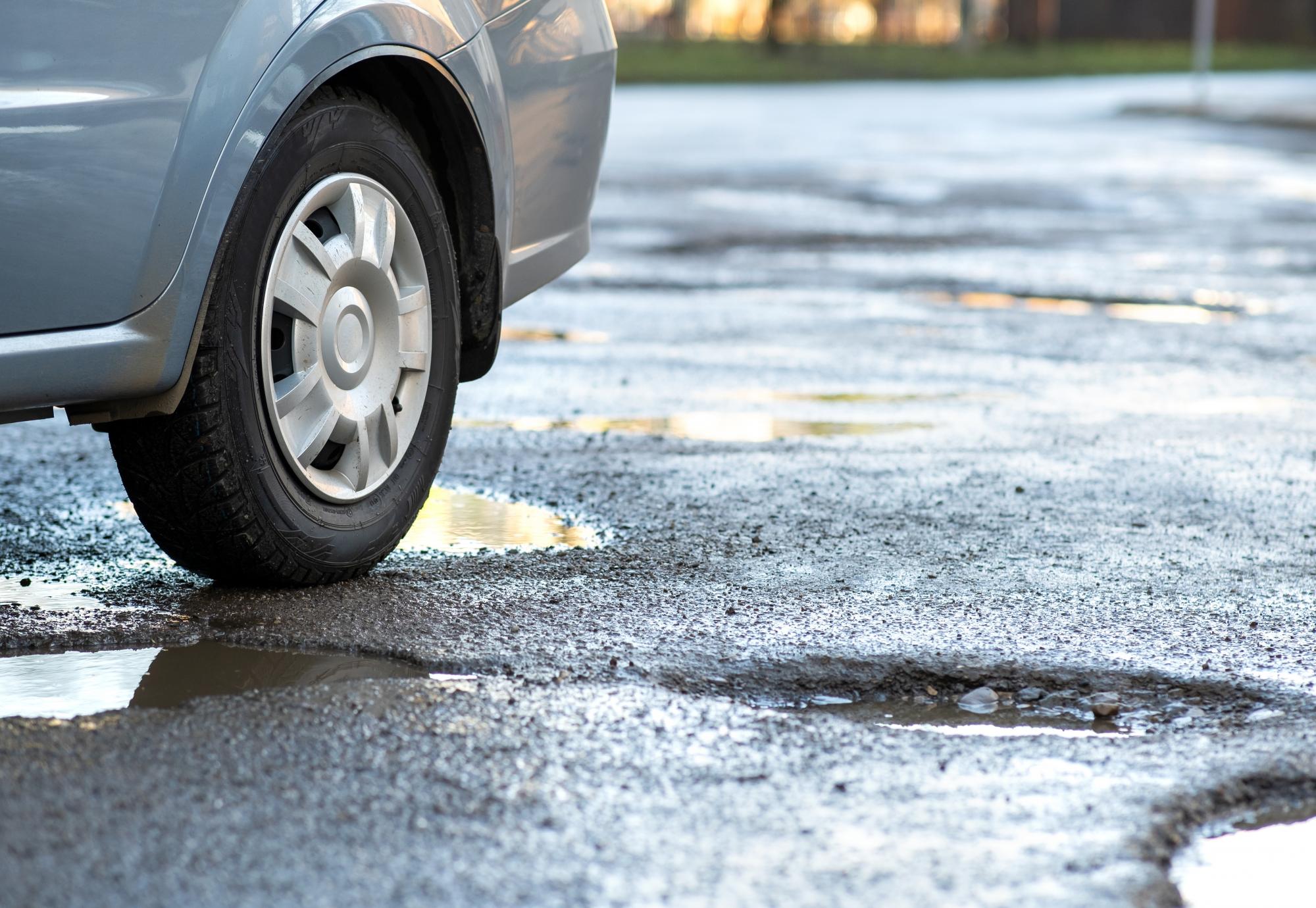 Pothole with a car about to drive over