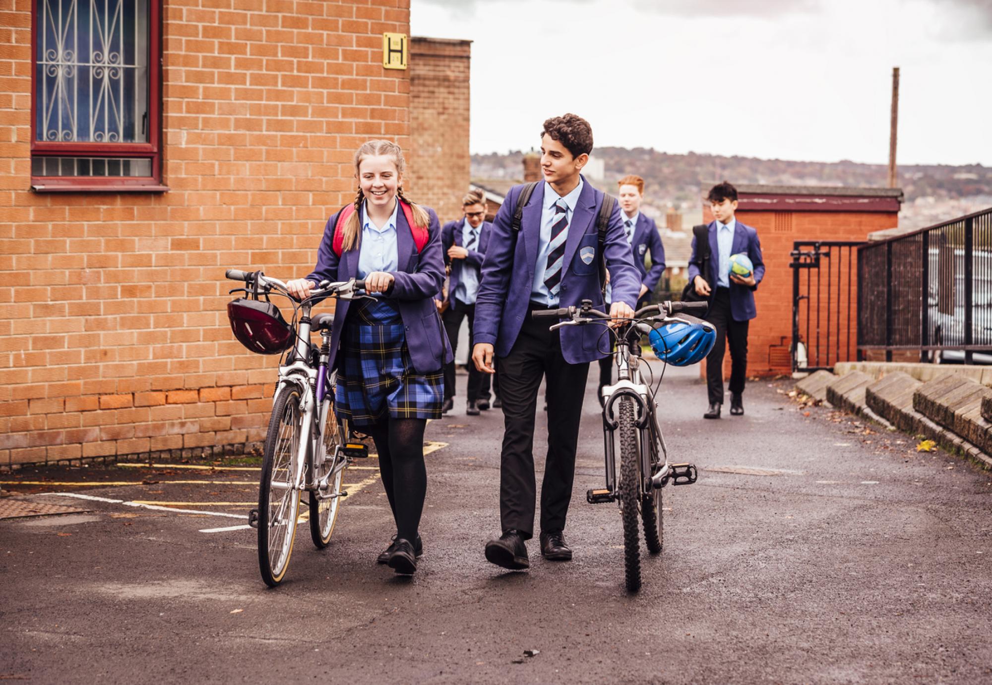 Students pushing bikes