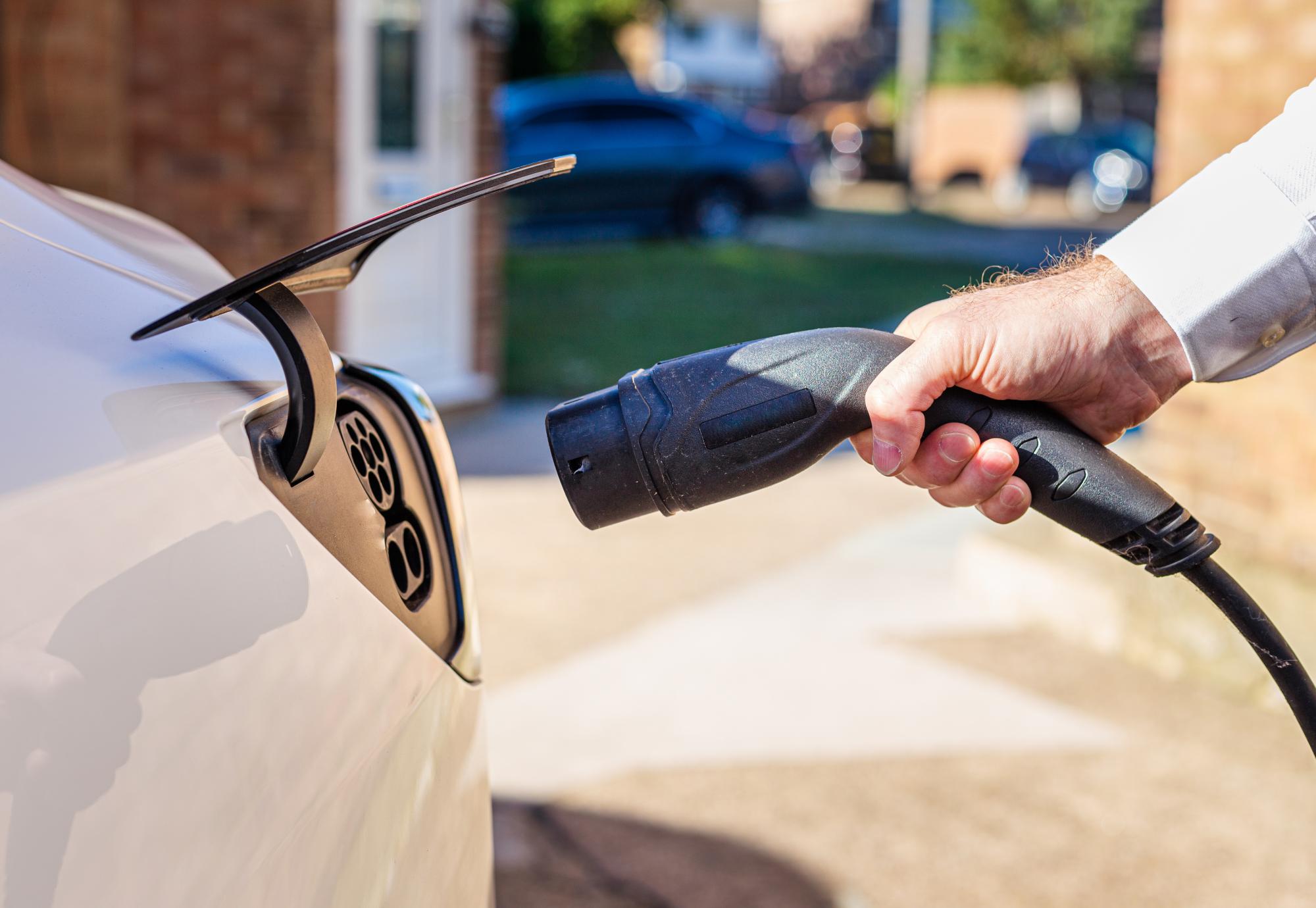 Man plugging an EV charger into his car