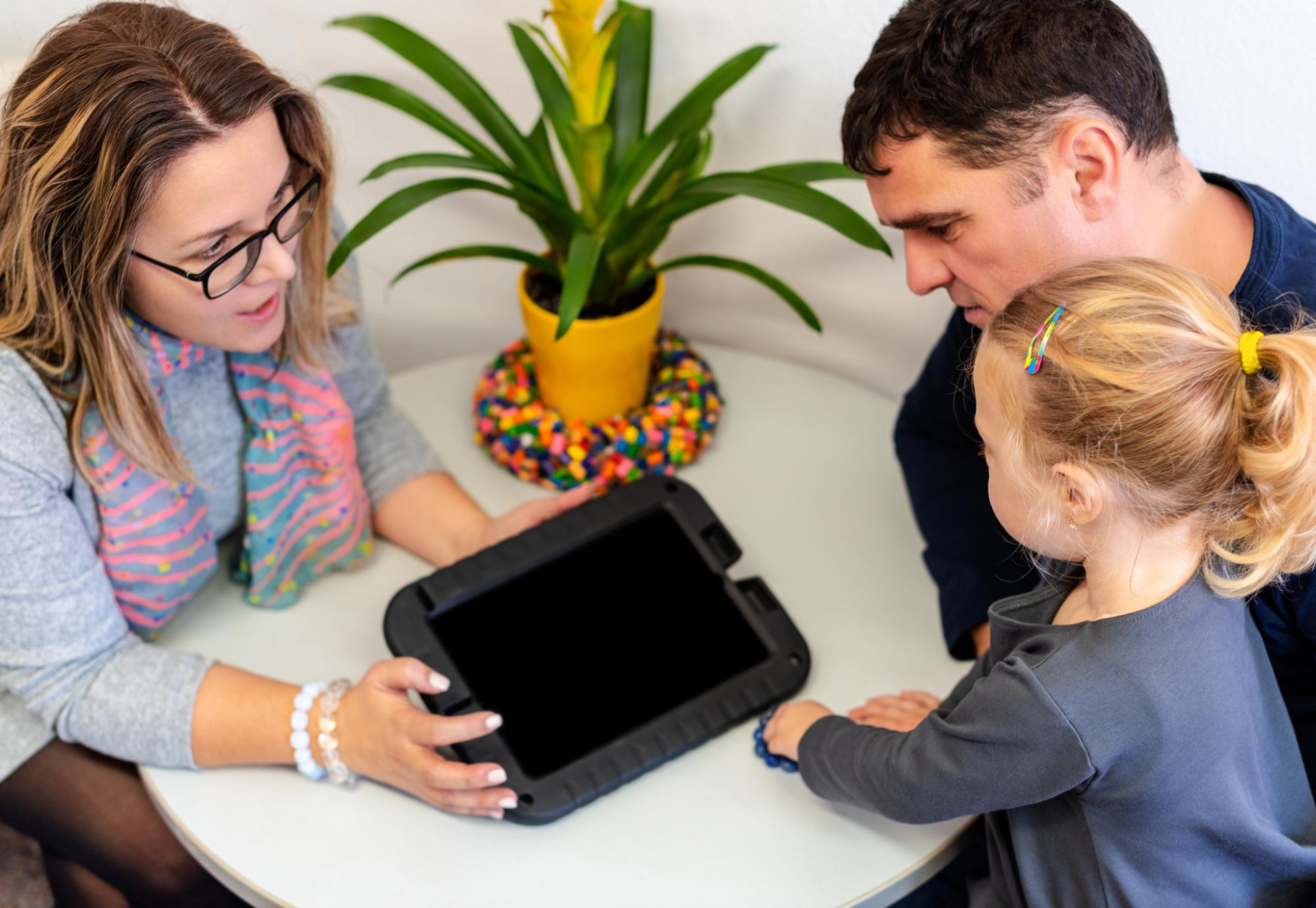 Father and toddler daughter in therapist office during counselling assessment meeting