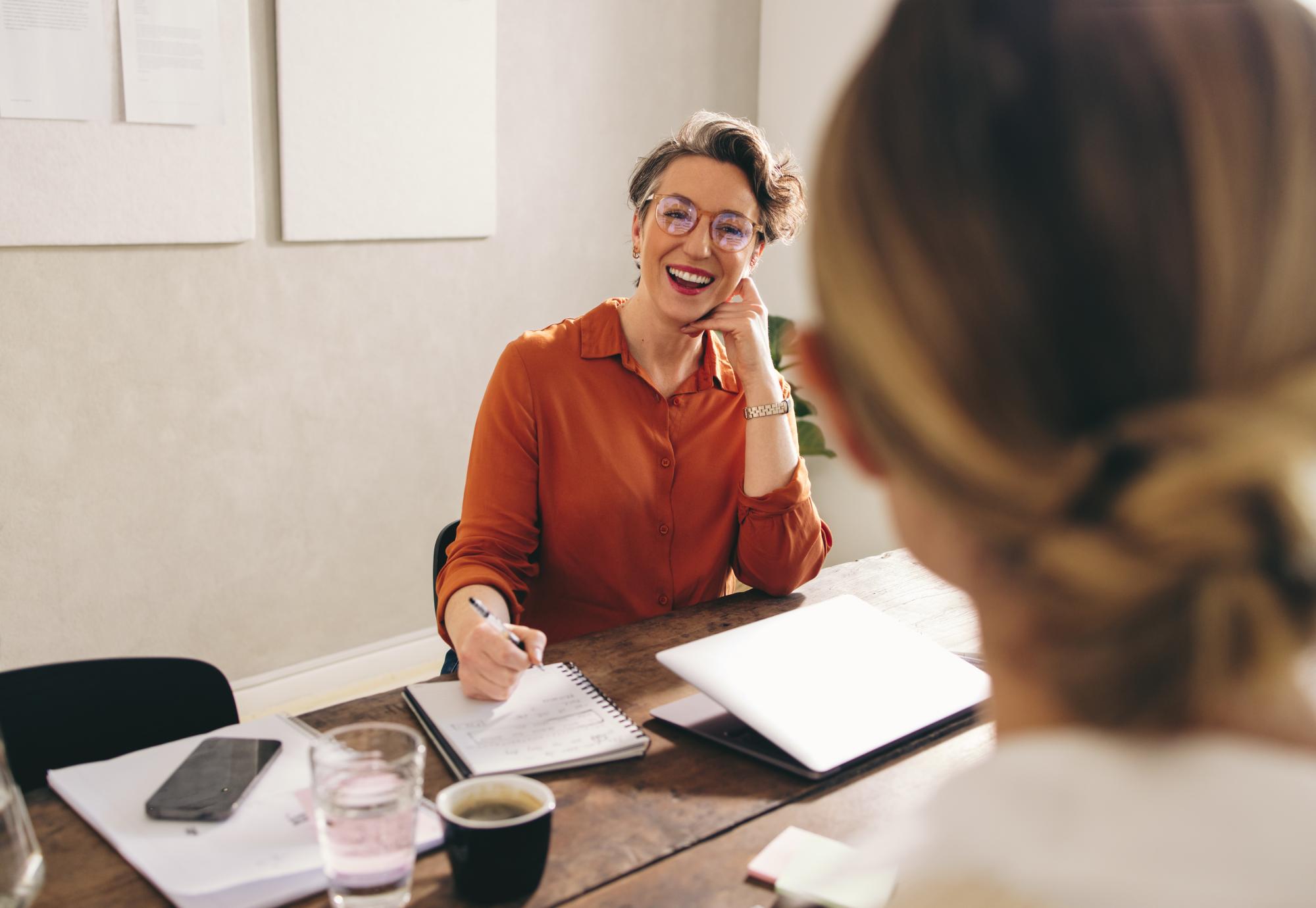 Happy businesswoman interviewing a job candidate