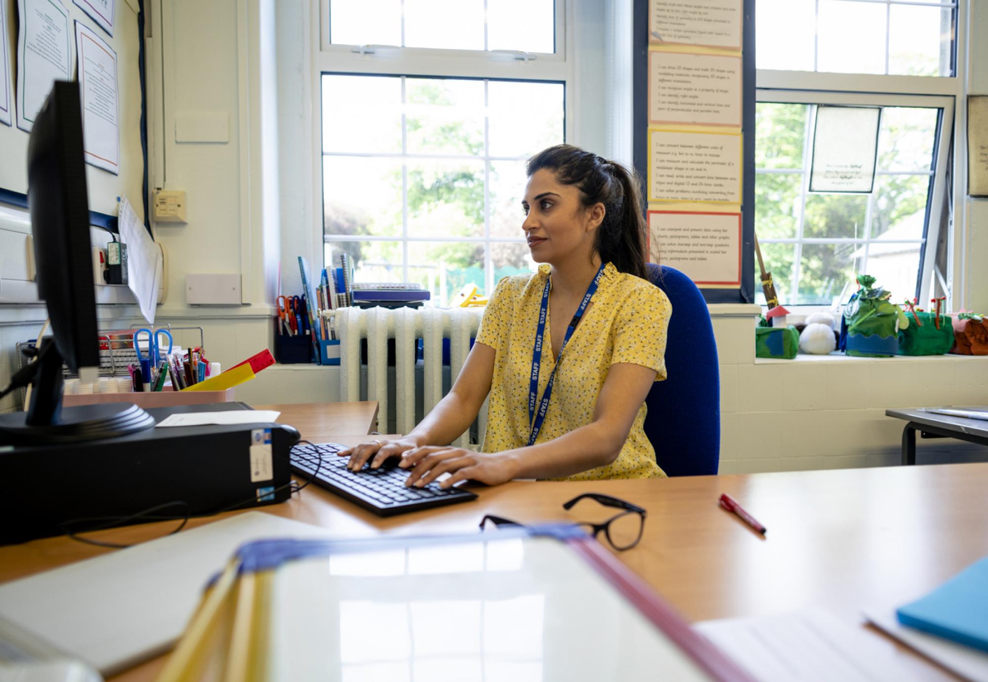 Teacher working on a computer