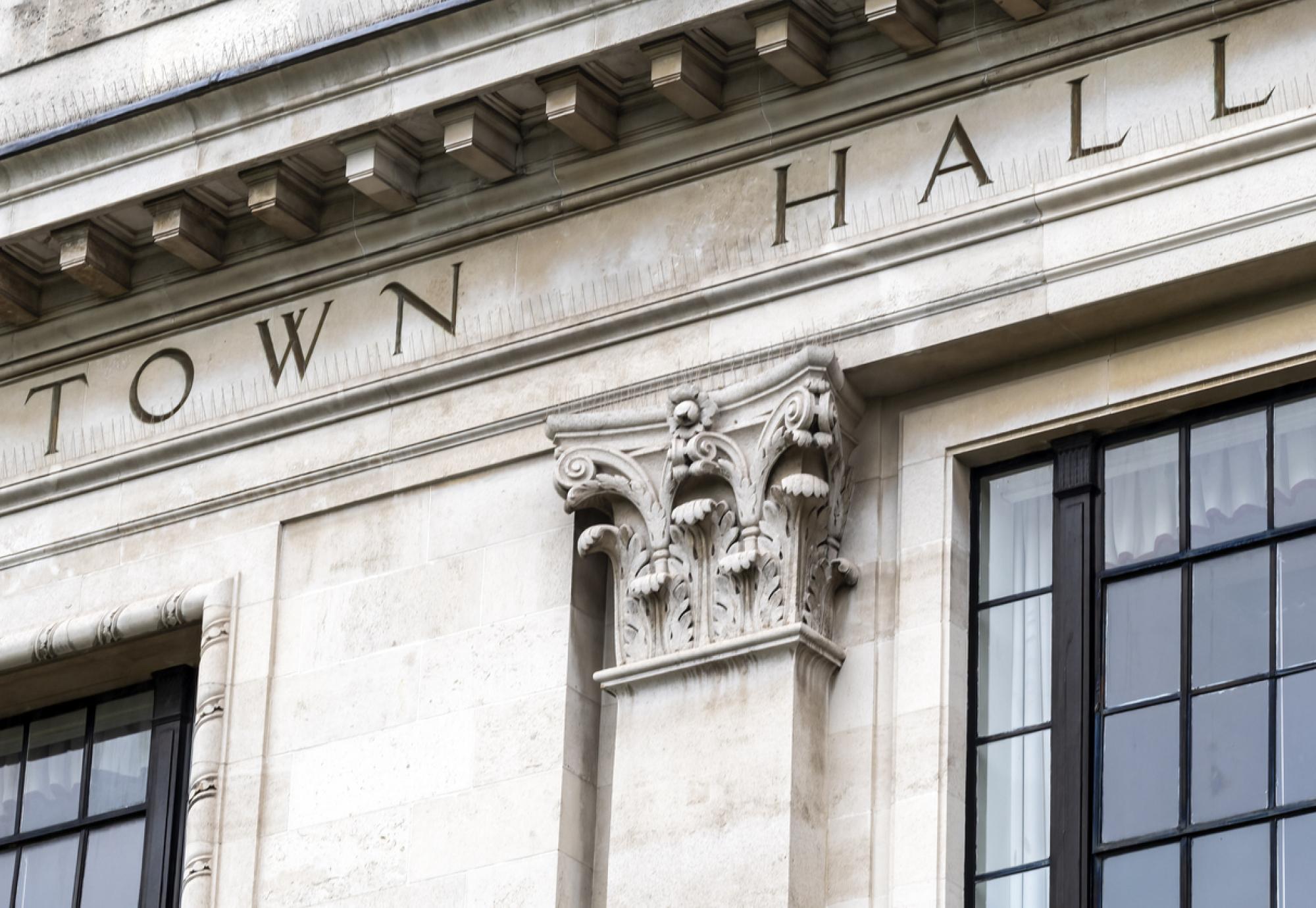 Town hall sign on exterior of local government office