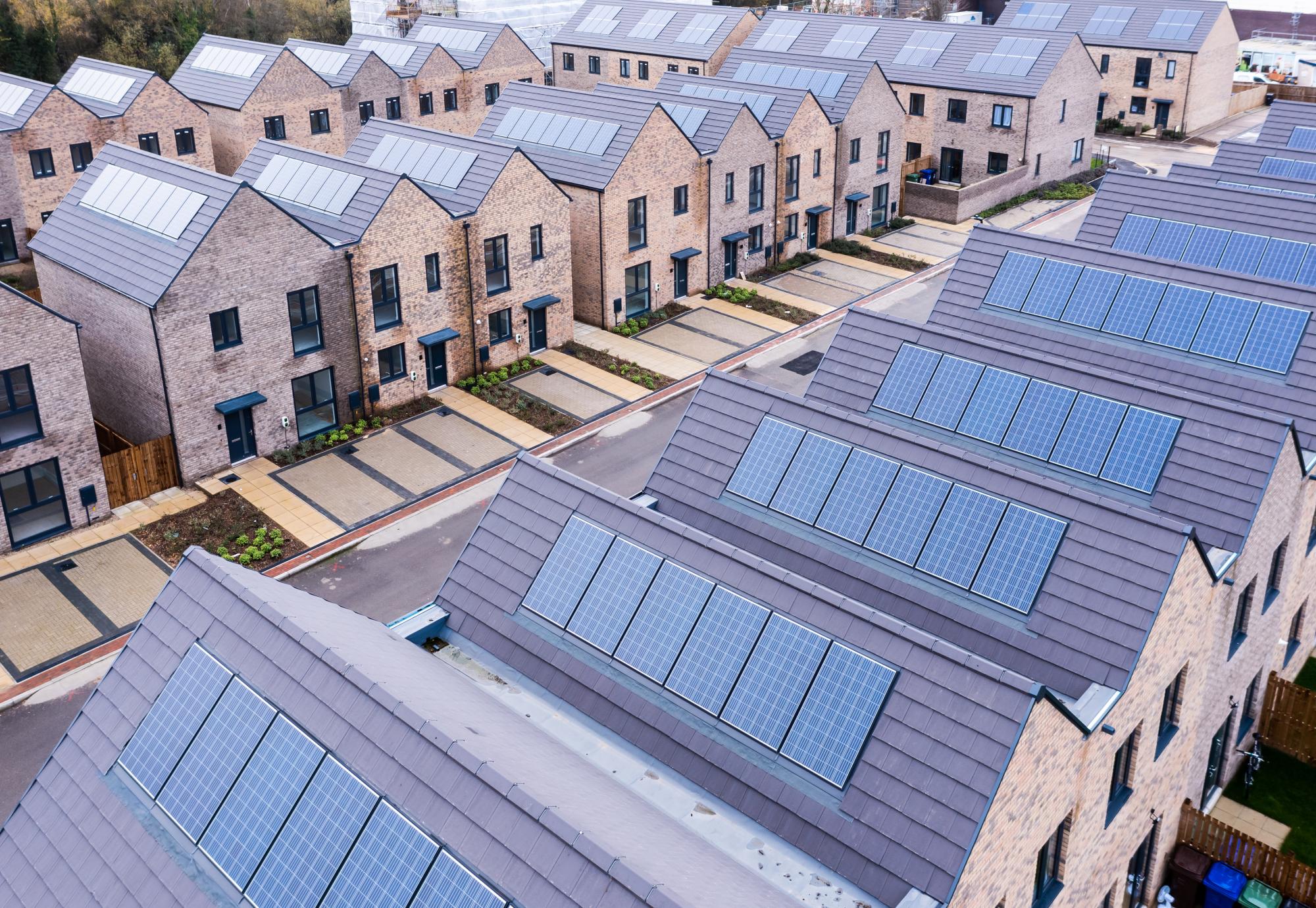 Aerial view of rows of energy efficient new build modular terraced houses in the UK