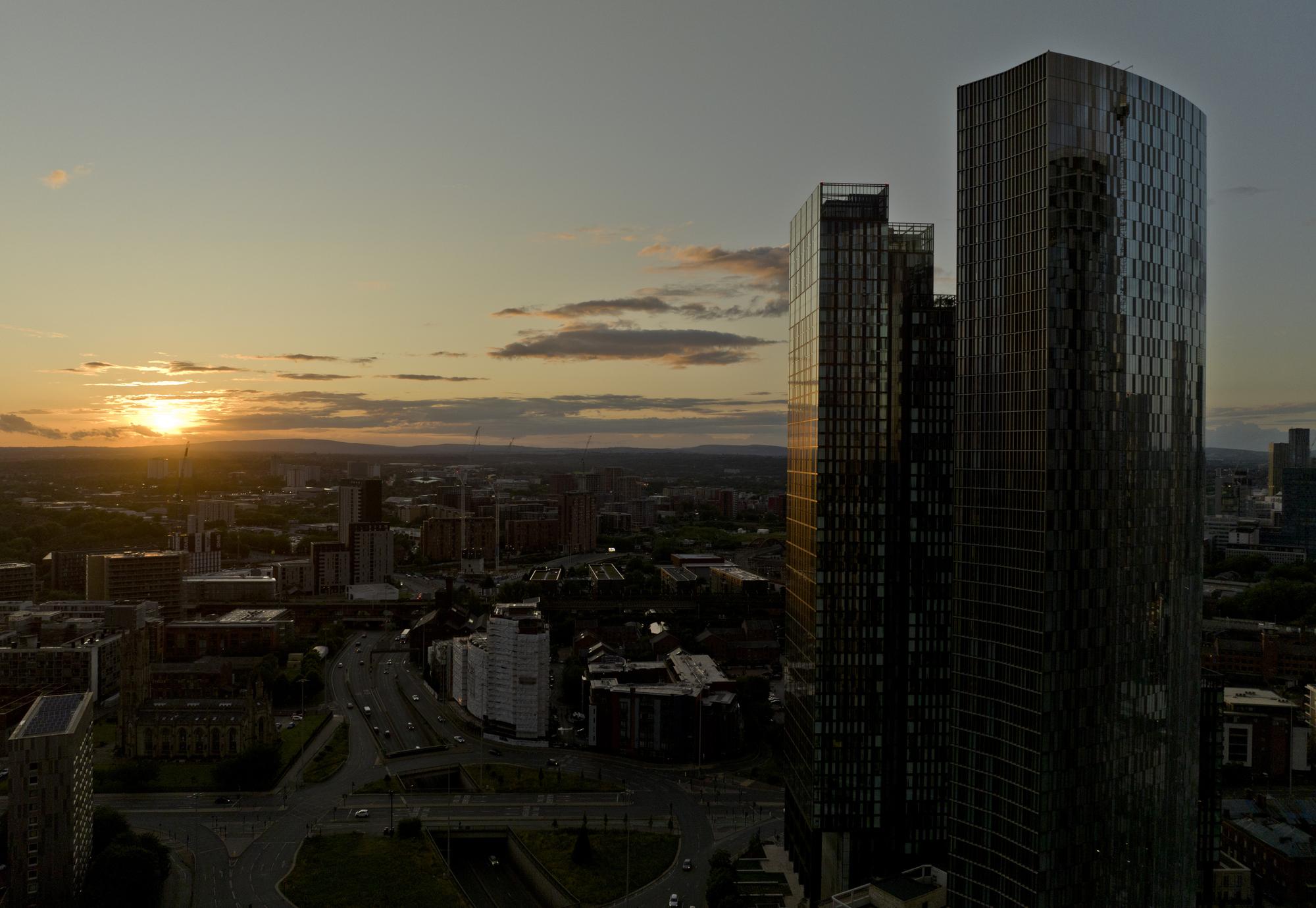 An aerial photograph of downtown Manchester at sunset