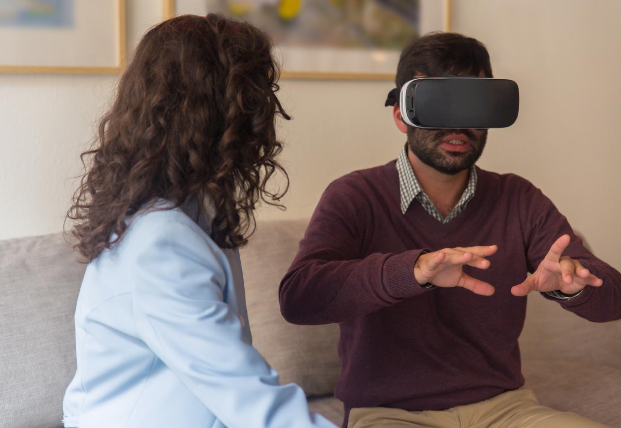 Front view of tranquil young man testing virtual reality headset