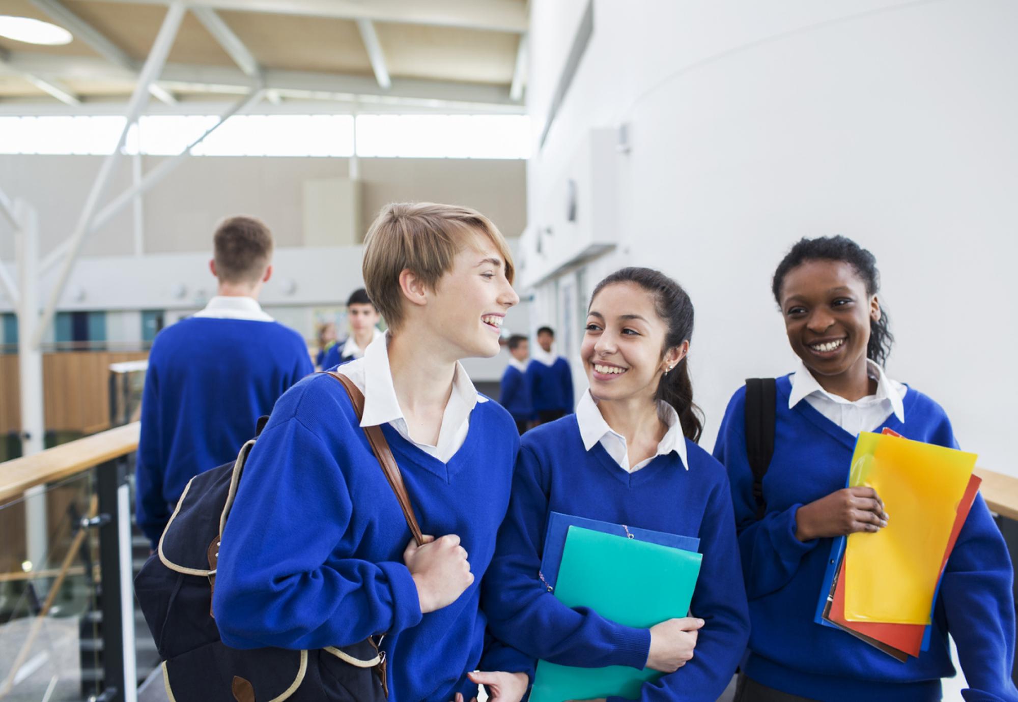 Smiling female students wearing school uniforms